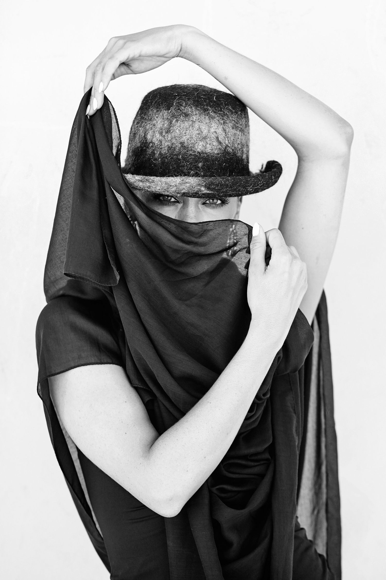 Black and white photograph of  a woman wearing a scarf around her head and a hat  - Marrakech by Ahmed Bahhodh