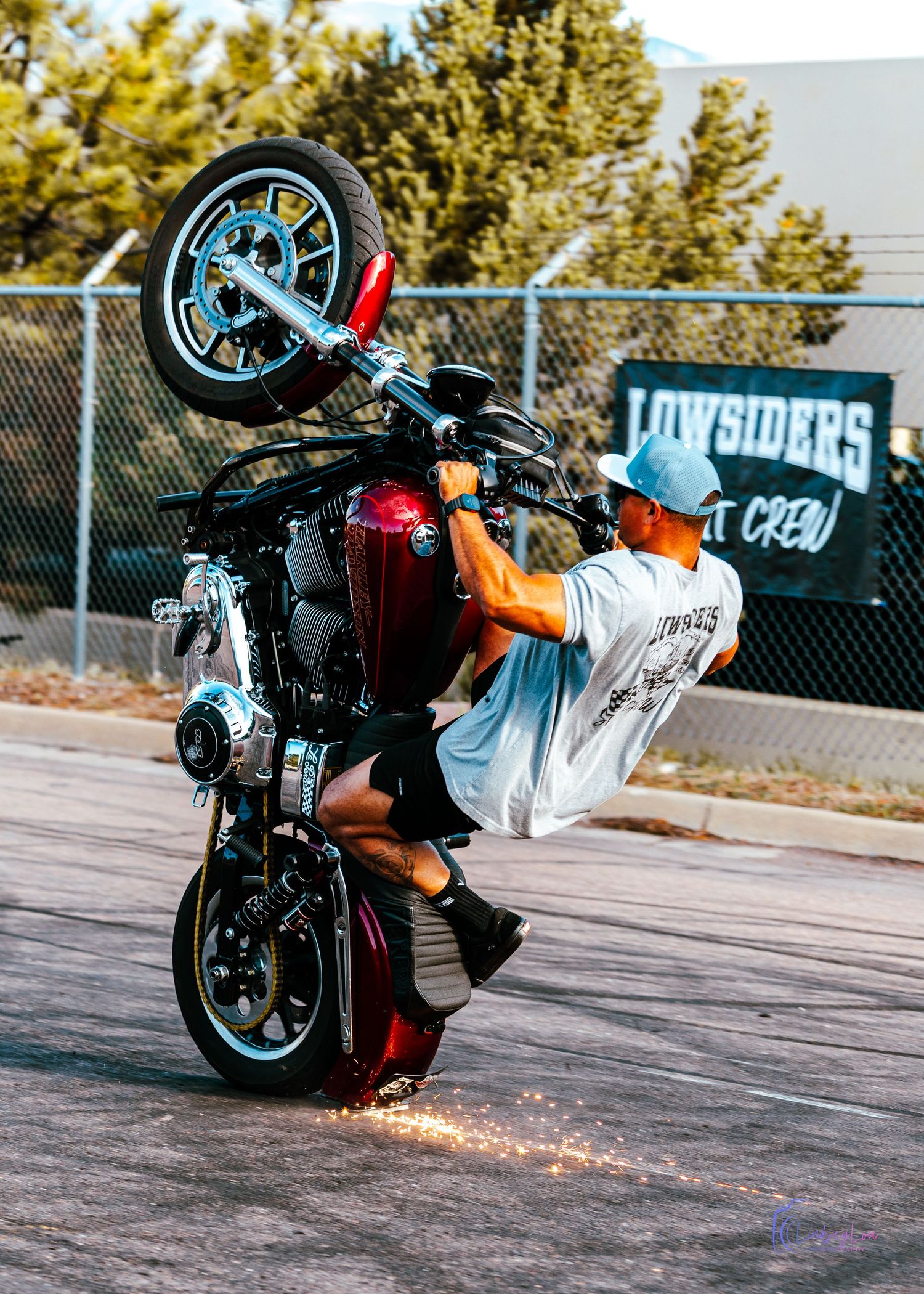 Man performing a trick on one wheel of his motorcycle