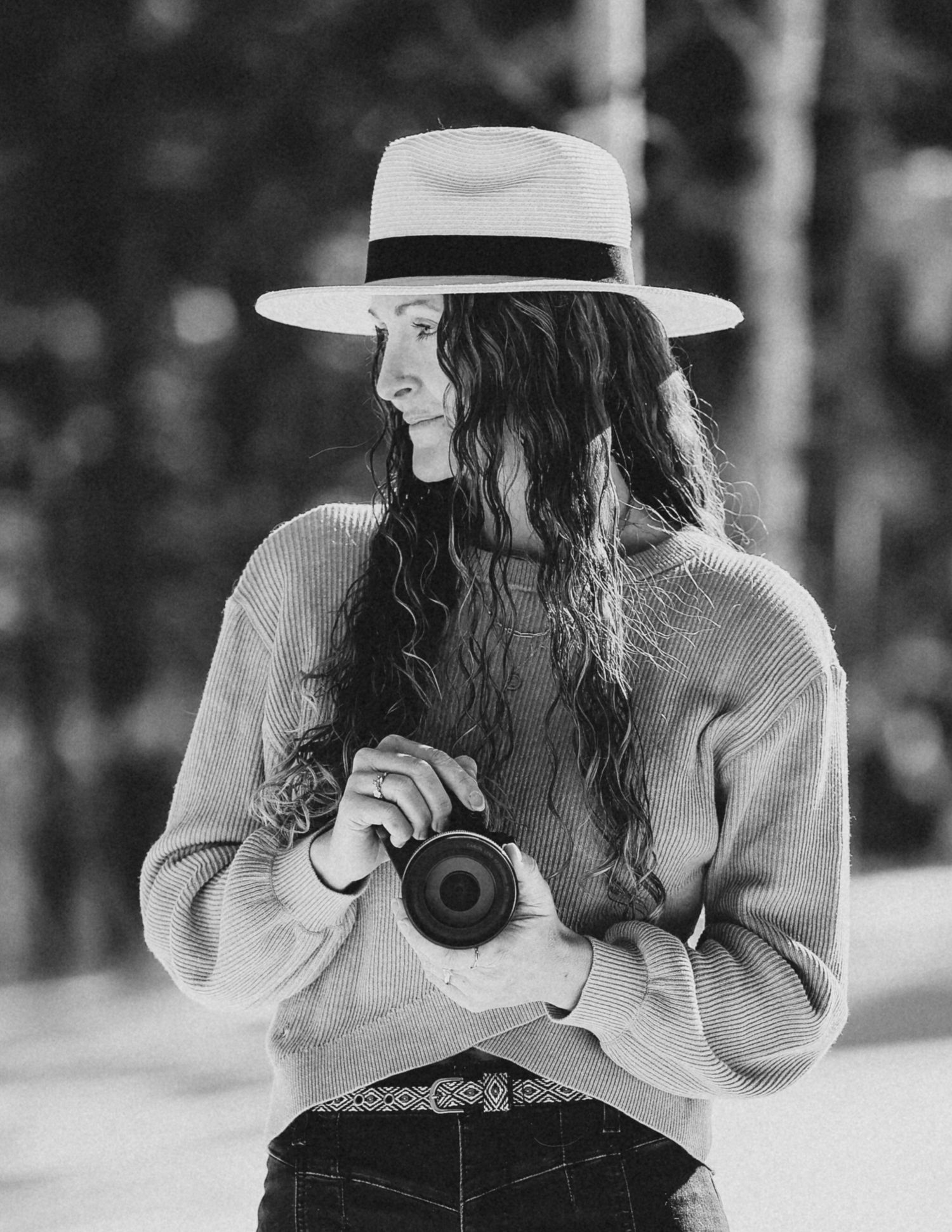 Woman holding a camera looking to the side