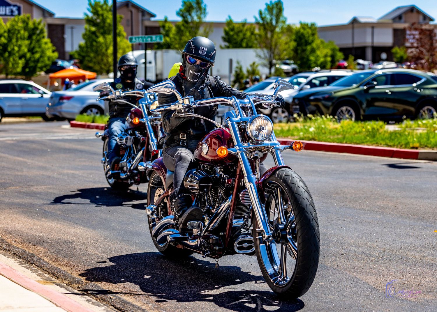 Motorcylist driving down a parking lot