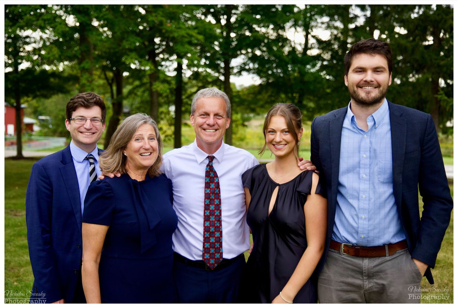 A family posing together outdoors