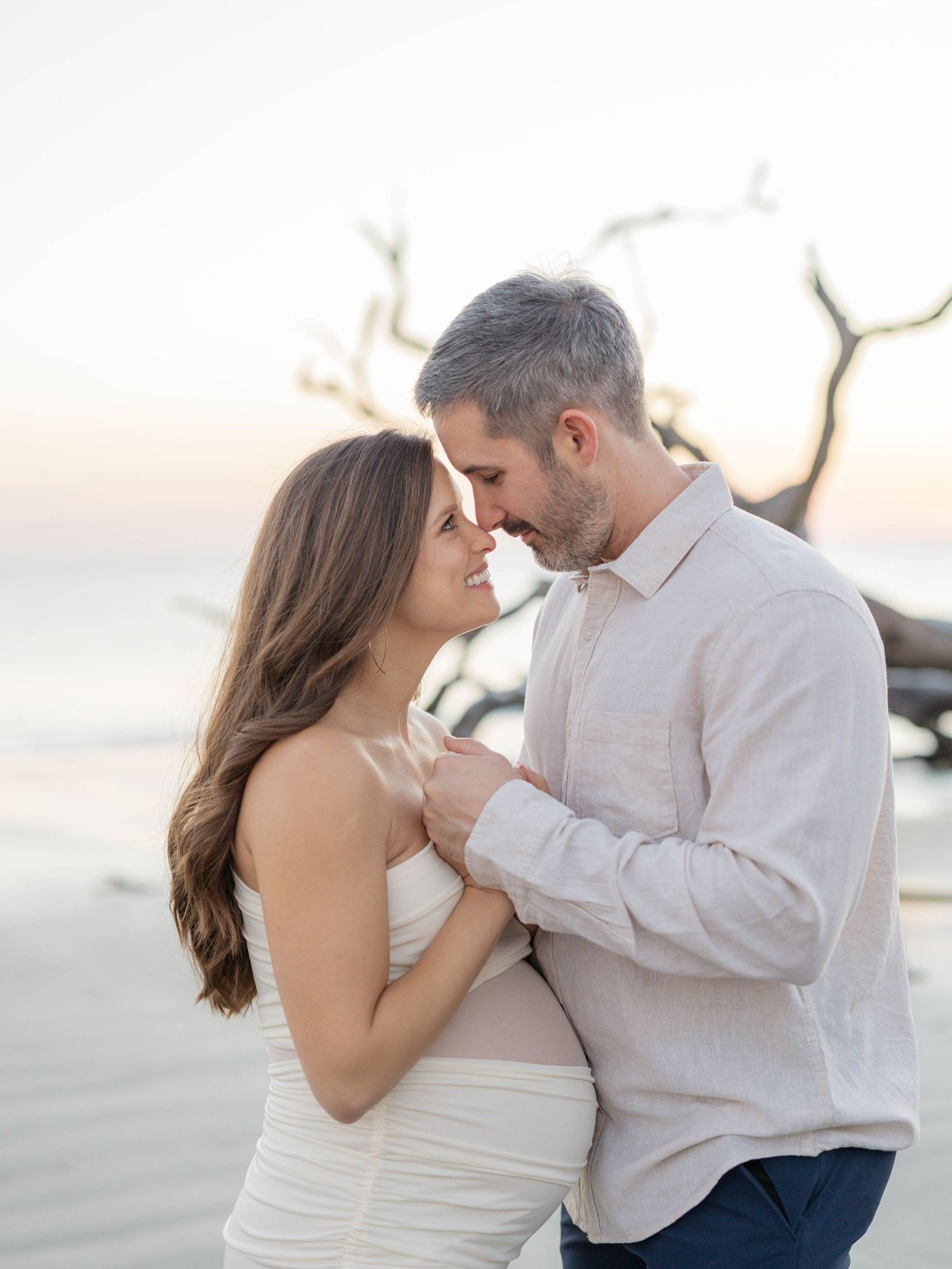 Romantic couple shares intimate moments at sunset on a beach in a series of tender embraces.