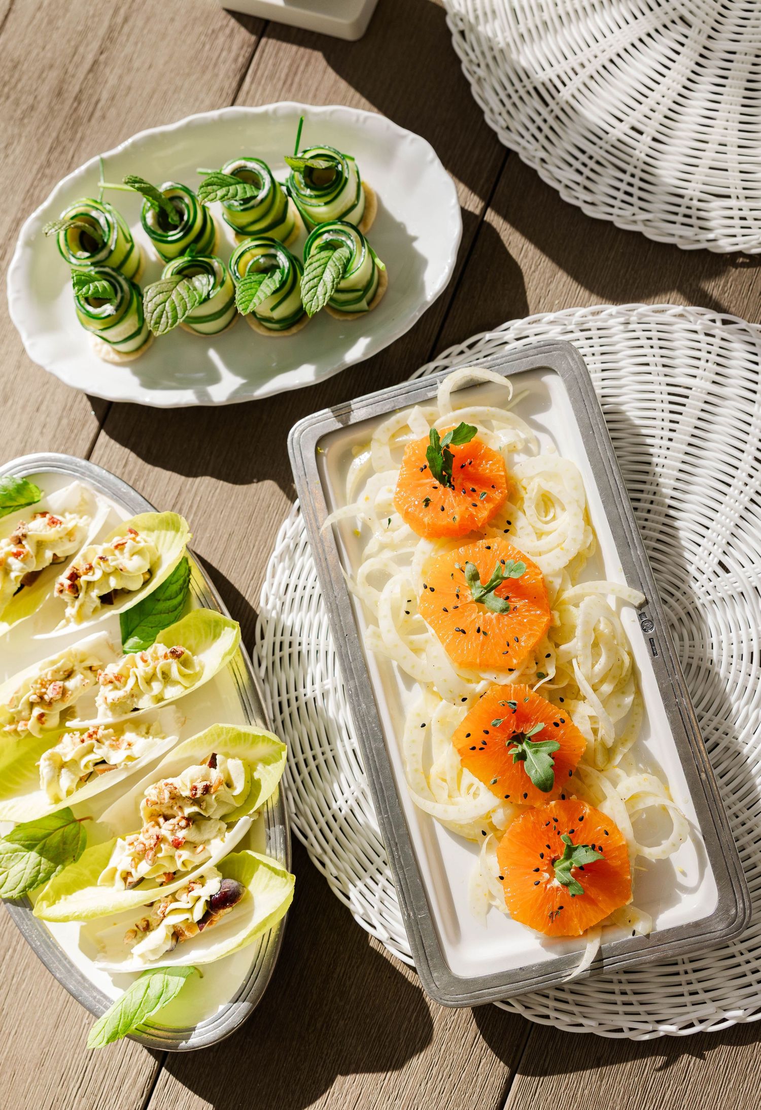 Elegant appetizer spread featuring zucchini rolls, lettuce wraps, and pasta with smoked salmon garnished with herbs.