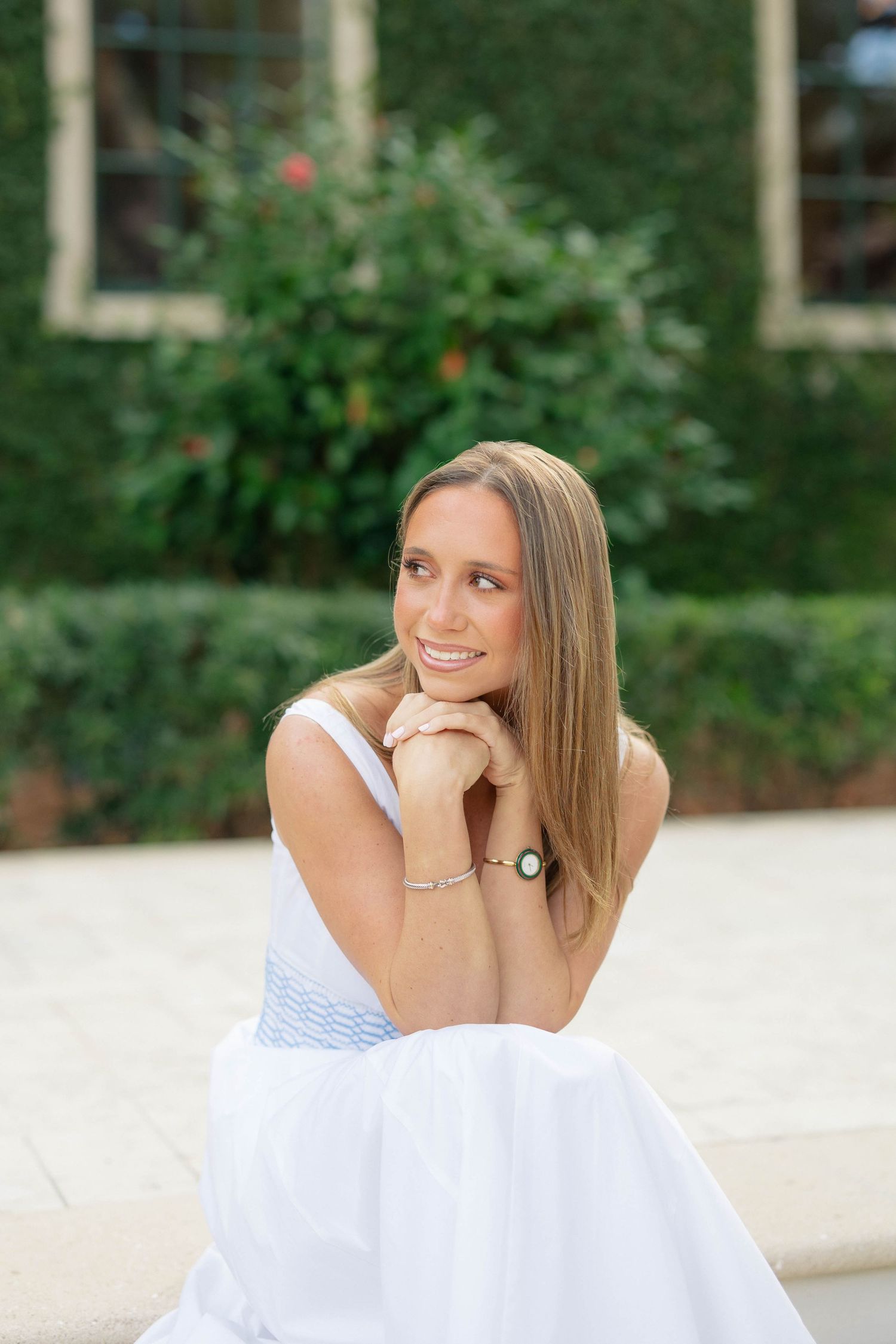 Portrait series of a person in a white off-shoulder top against a green outdoor background.