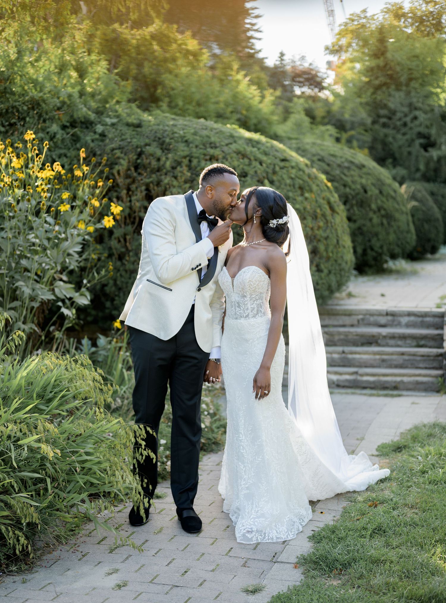 A romantic wedding couple shares tender moments in a garden setting during golden hour photography in Scarborough Ontario.