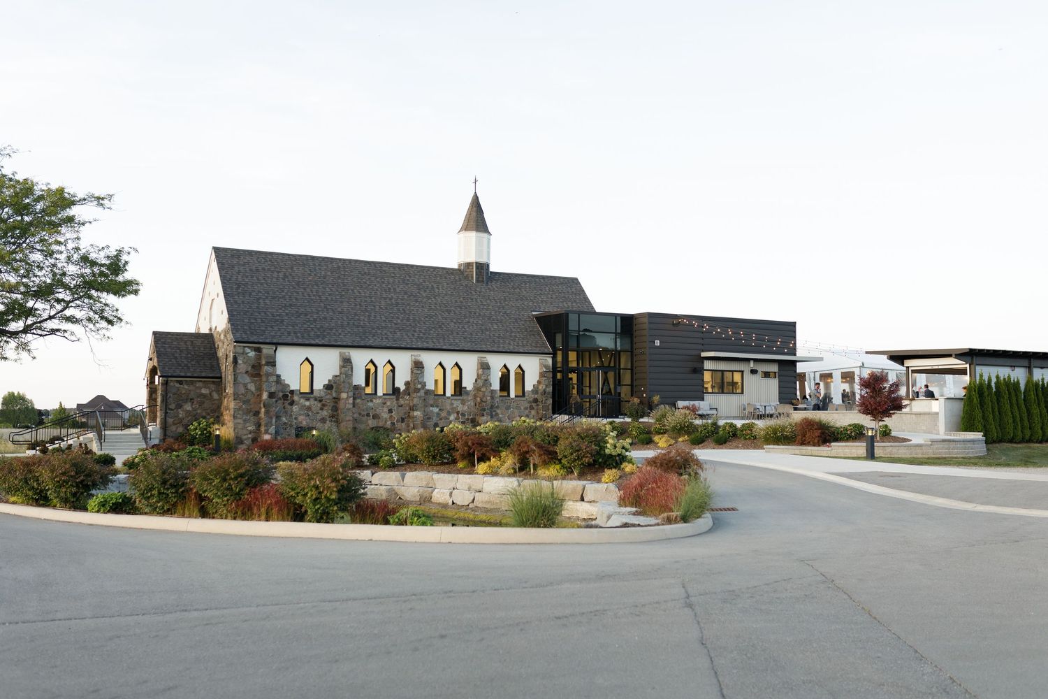 A panoramic view shows a series of church buildings and structures connected along a rural landscape.