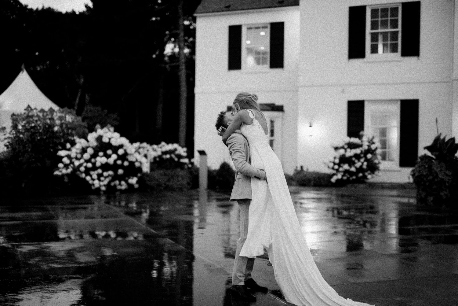 Black and white wedding photos arranged in a collage showing romantic outdoor moments at a classic venue.