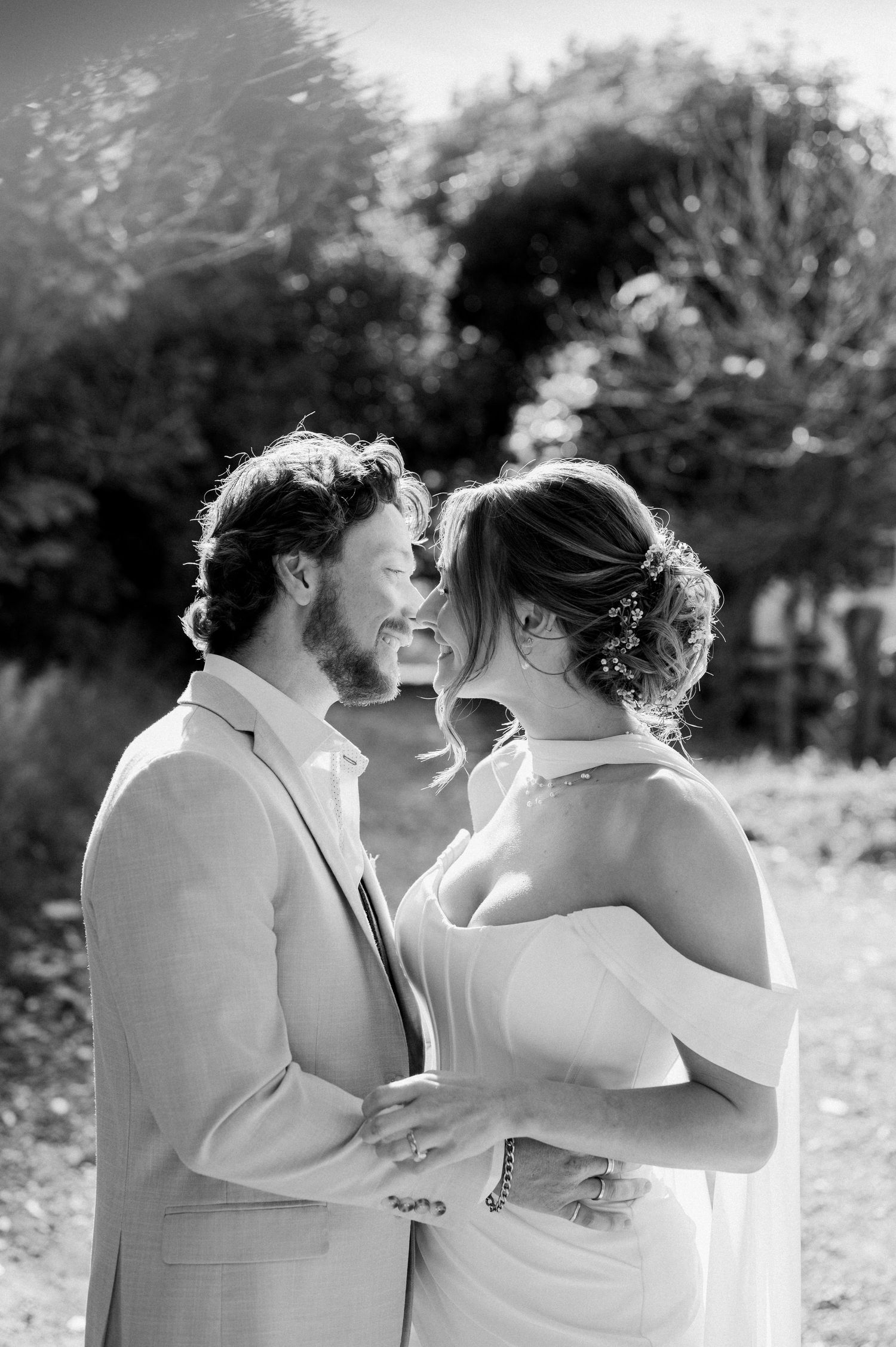 A series of intimate black and white wedding photos showing tender moments between newlyweds.