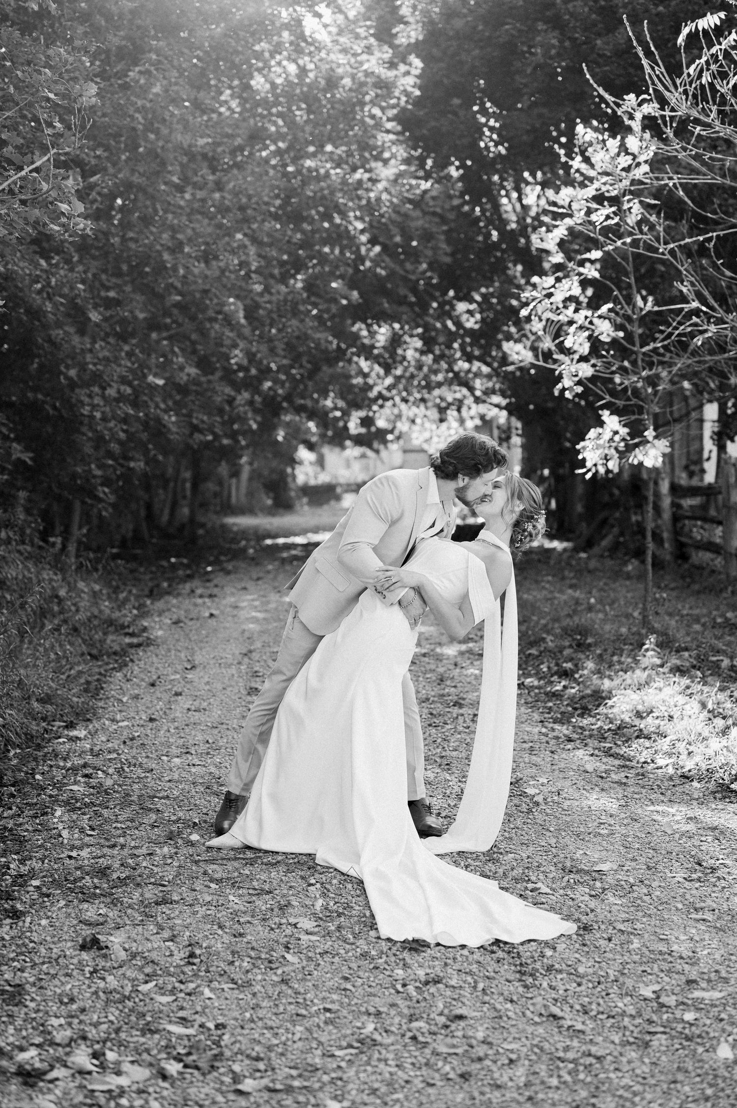Black and white wedding photos showing romantic moments in a garden setting.