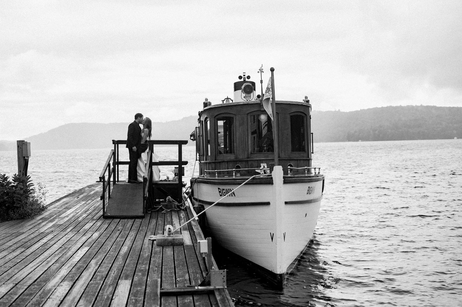 A series of vintage black and white photographs showing boats docked at wooden piers along a peaceful waterfront.