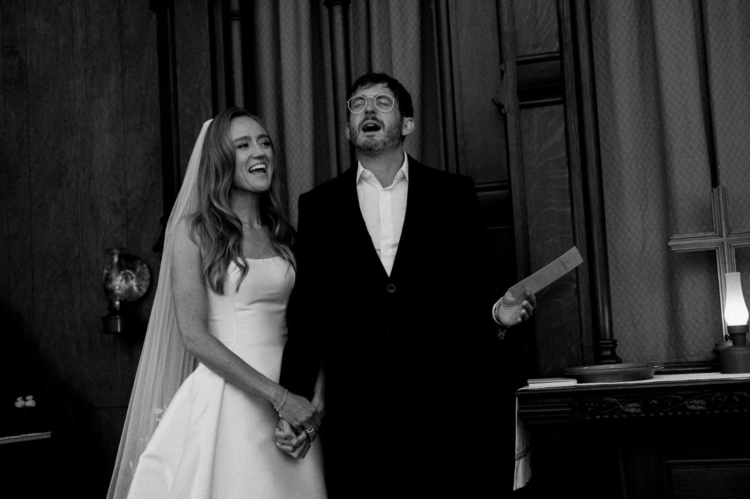 A sequence of candid black and white wedding photos showing joyful moments between a couple during their celebration.