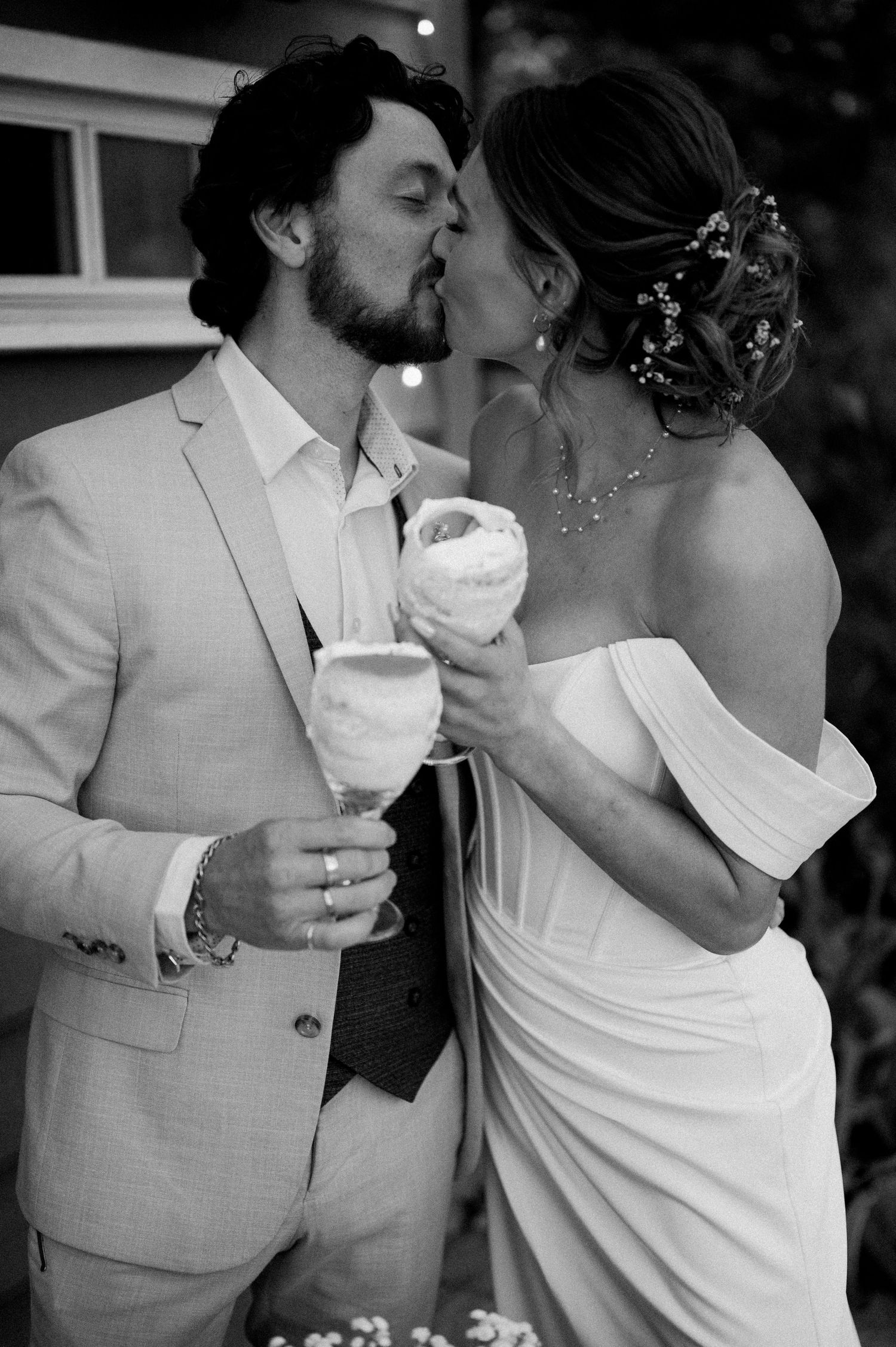 A romantic black and white series showing intimate moments between a couple at their wedding.
