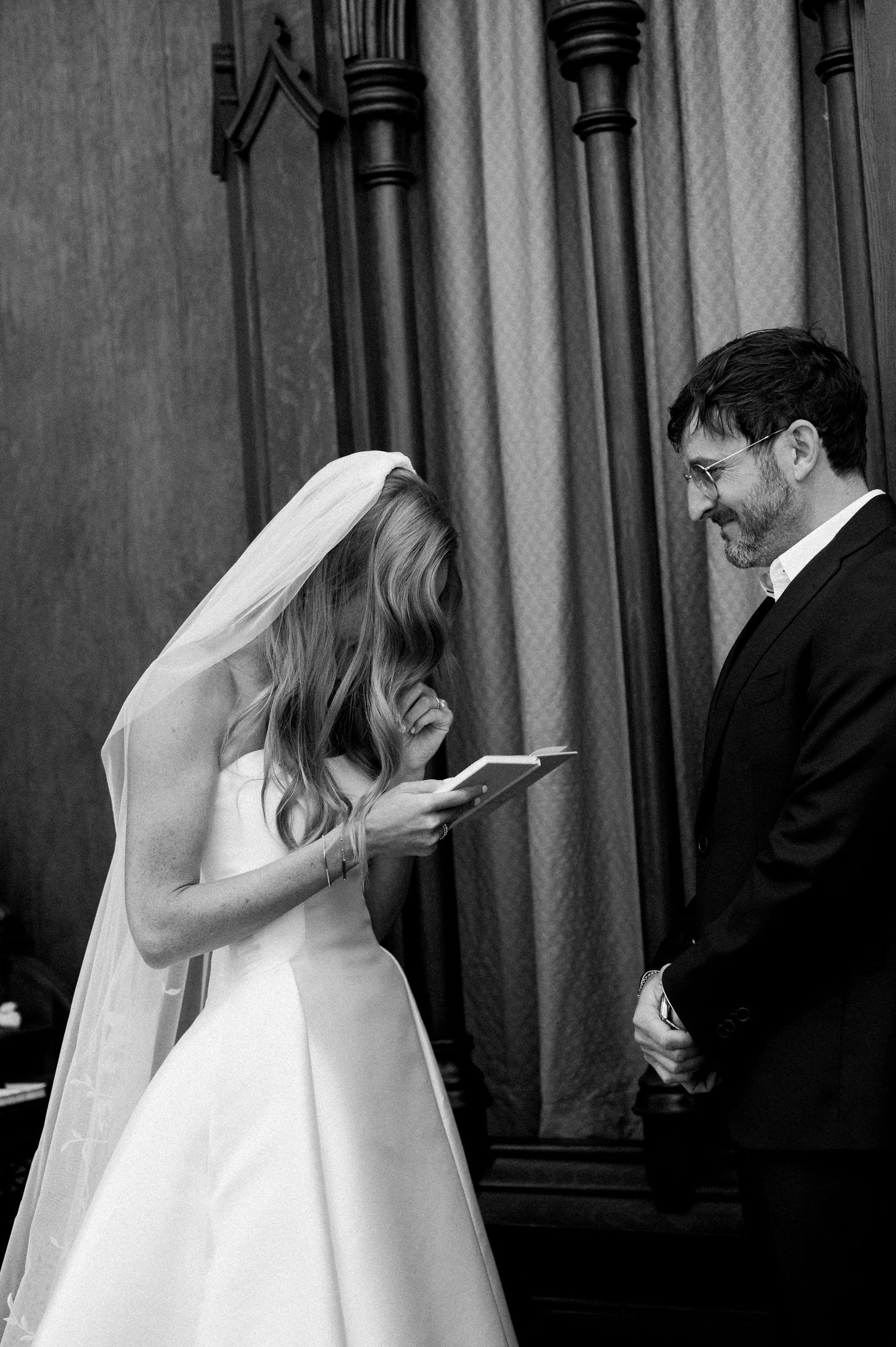 A series of black and white photos showing a bride and groom in a candid emotional moment during their wedding ceremony.