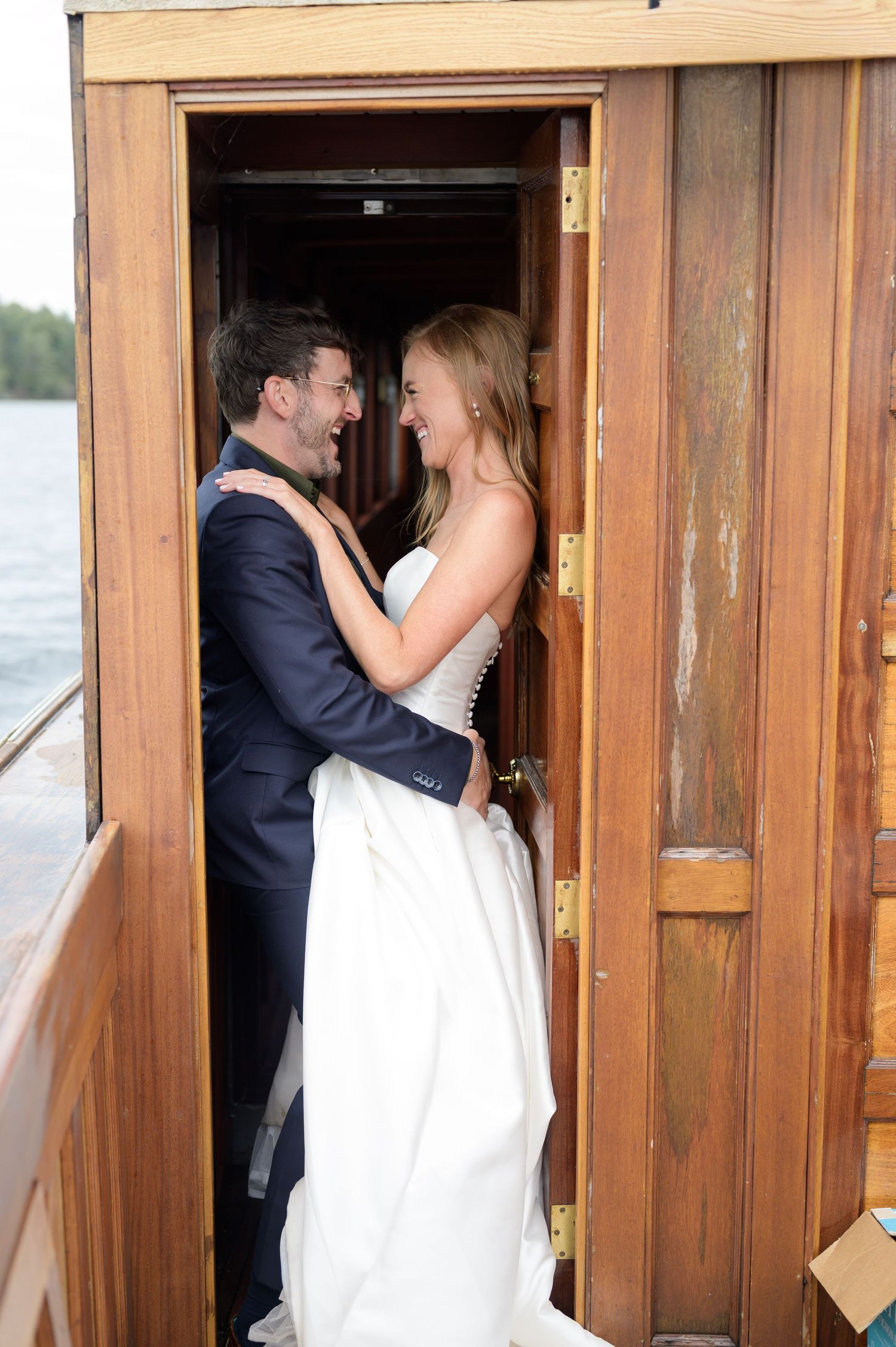 A romantic sequence of wedding photos showing a couple sharing a first look through a wooden doorway.