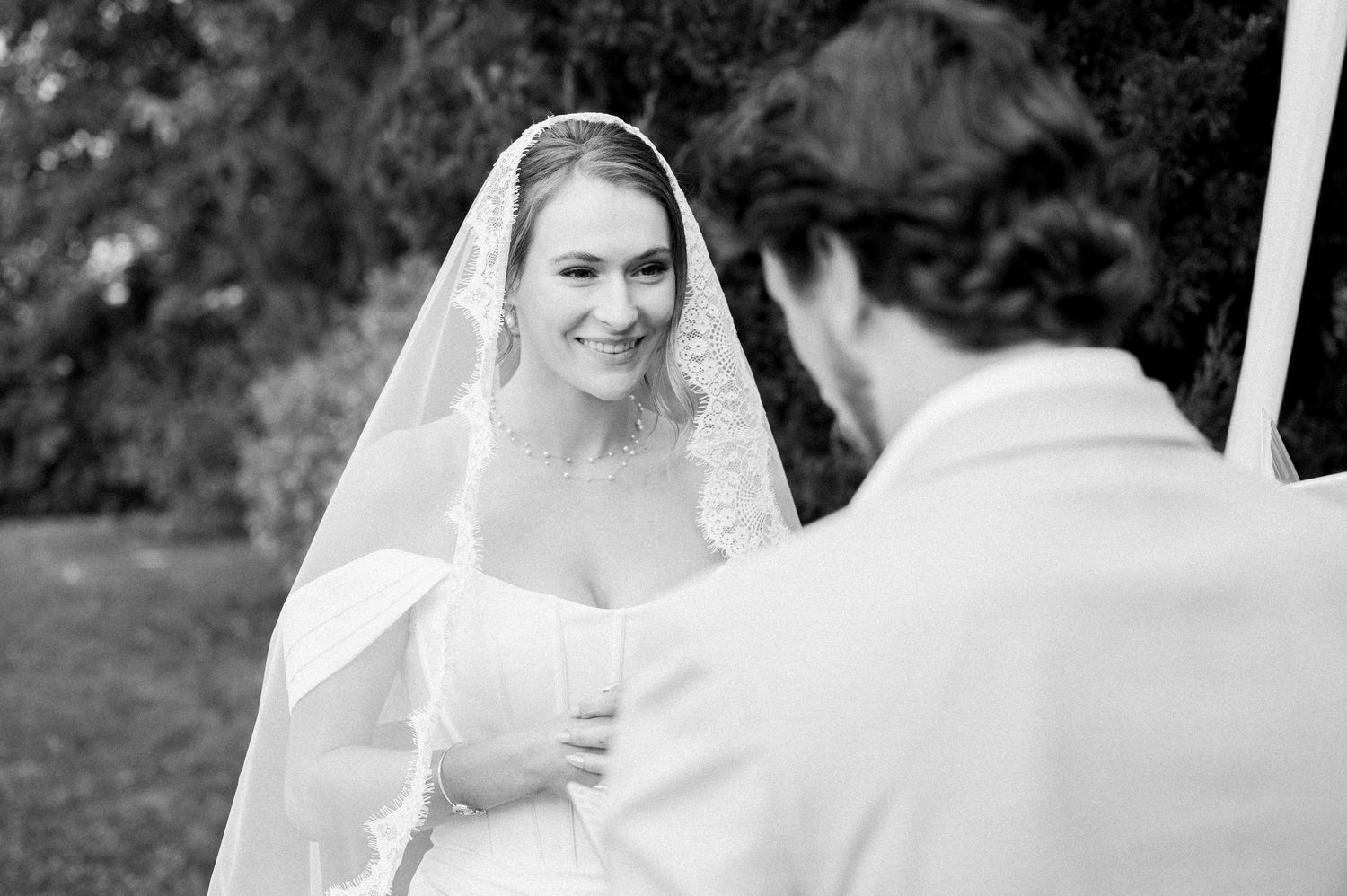 A bride and groom share a romantic moment together during their outdoor wedding ceremony.