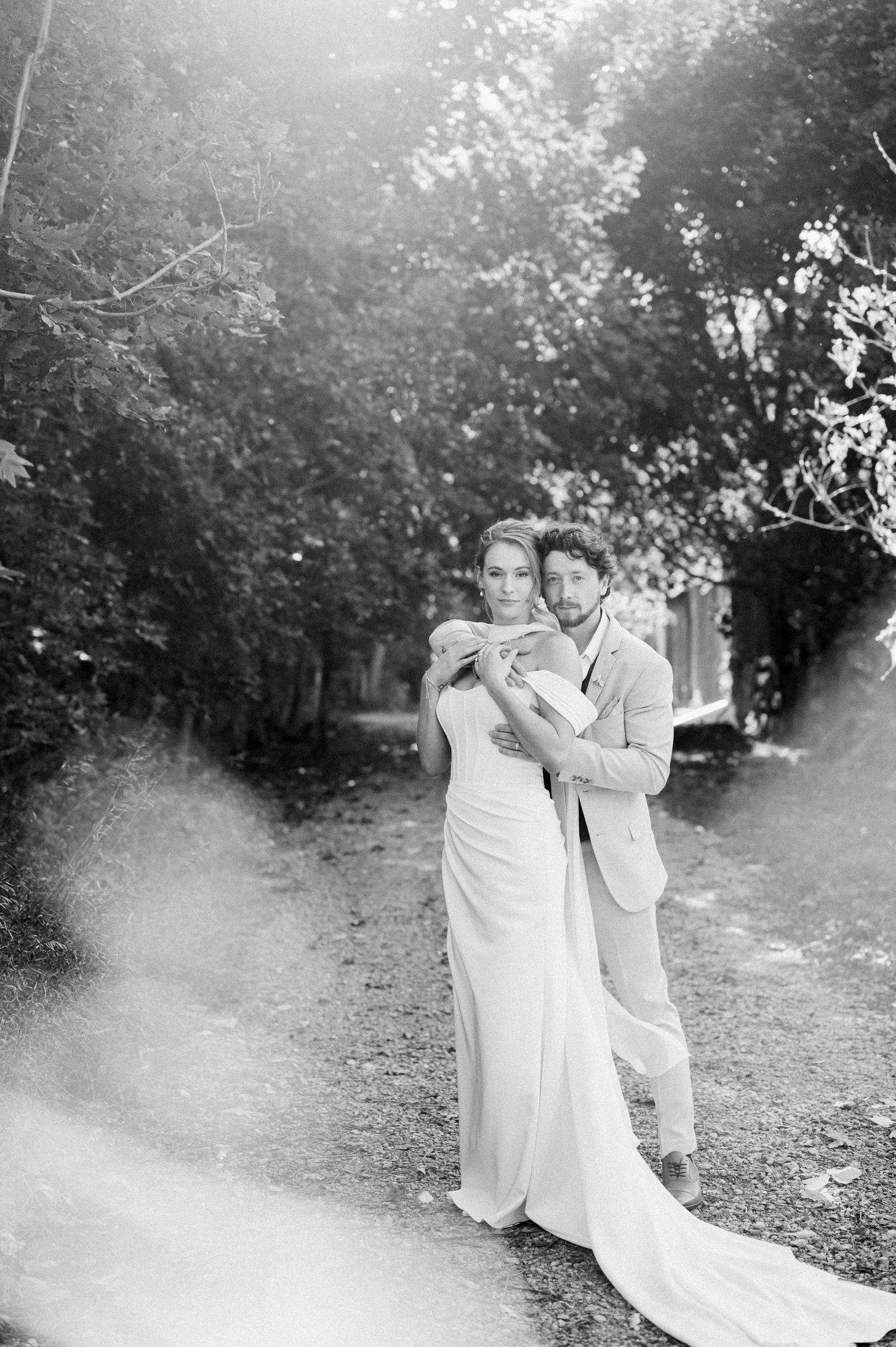 A romantic black and white photo series captures a couple dancing together in a dreamy outdoor garden setting.
