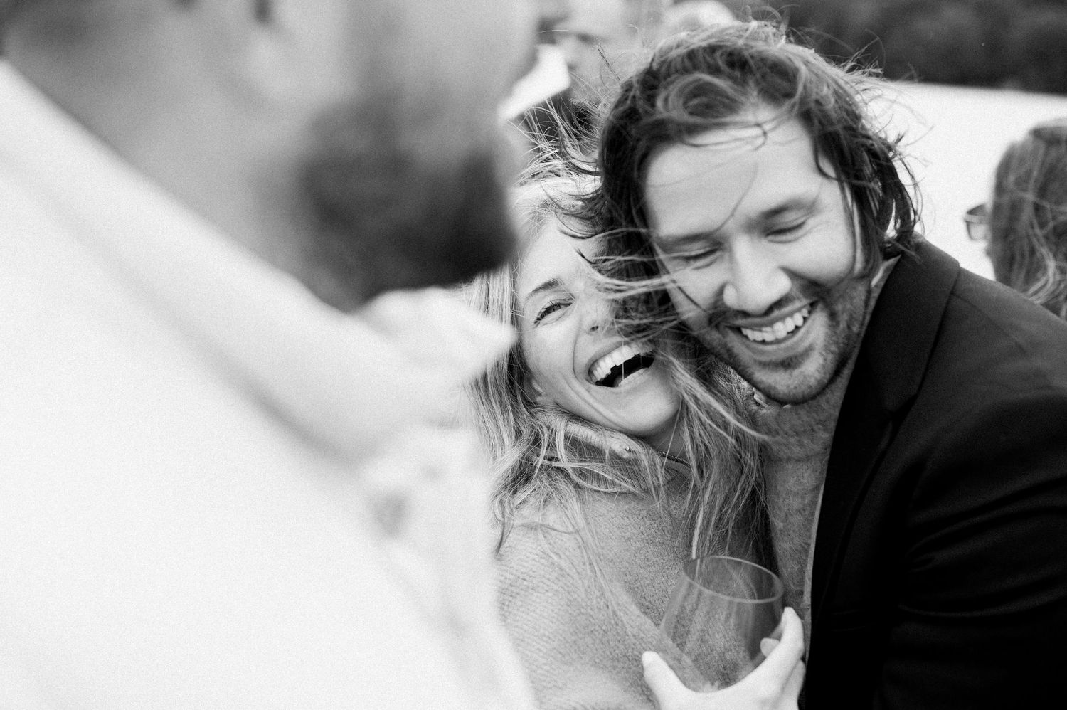 A series of black and white photos showing joyful expressions and laughter during candid moments.