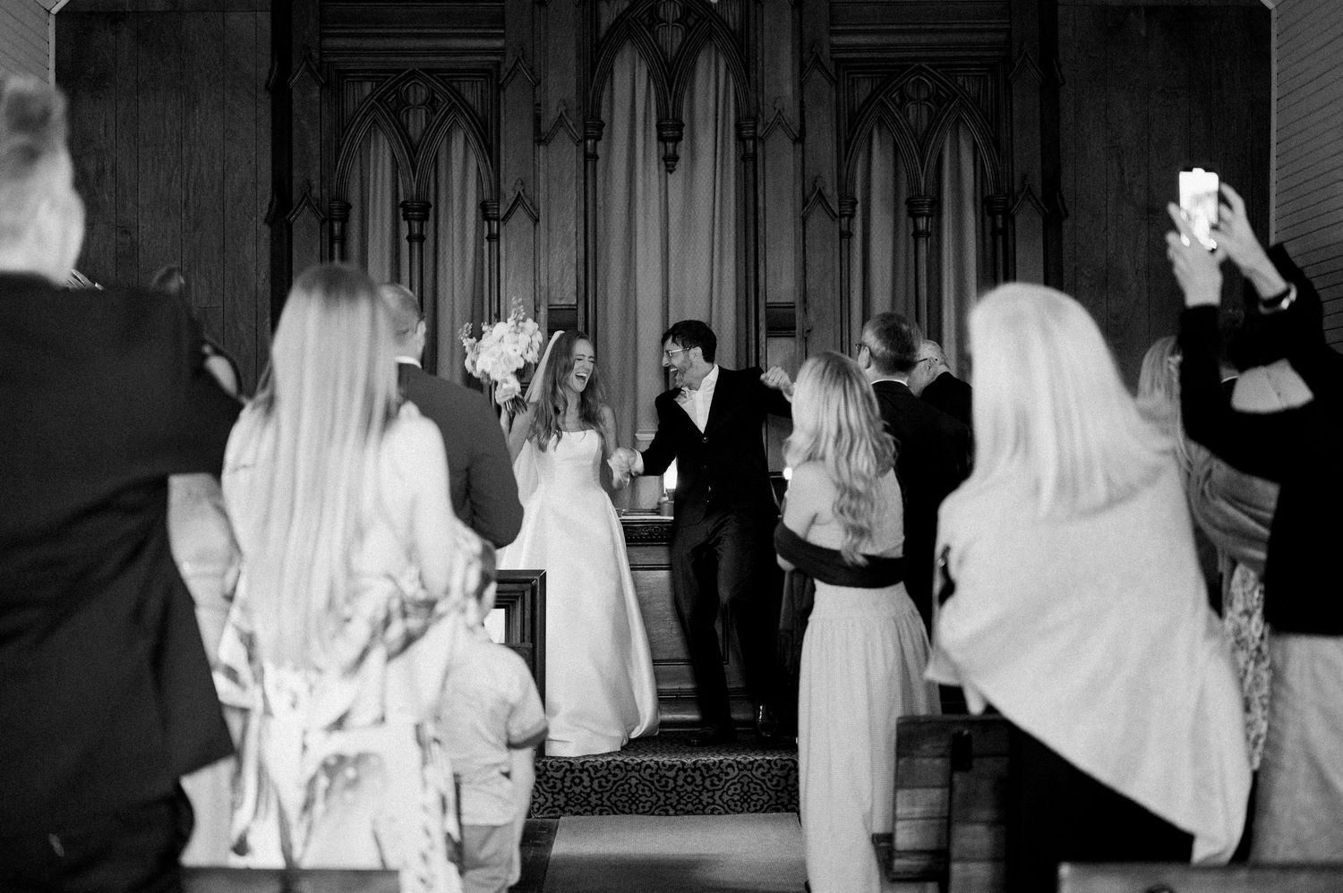 Black and white photo series showing wedding reception dancing with people in formal attire and white dresses.