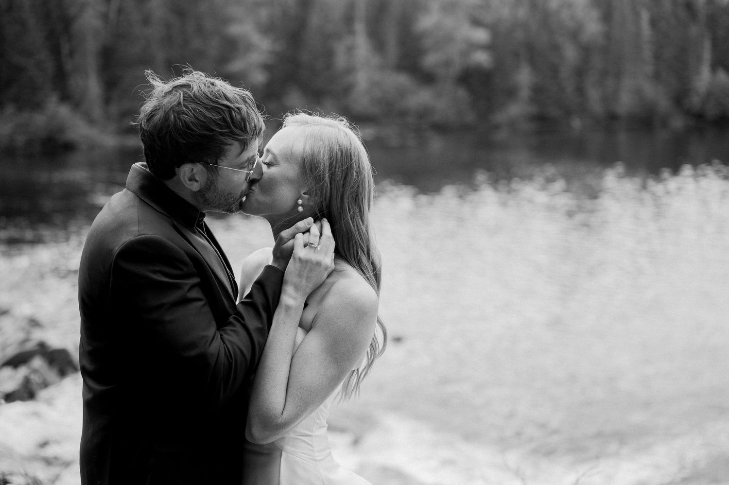 A romantic black and white photo series showing intimate moments between a couple in an outdoor setting.