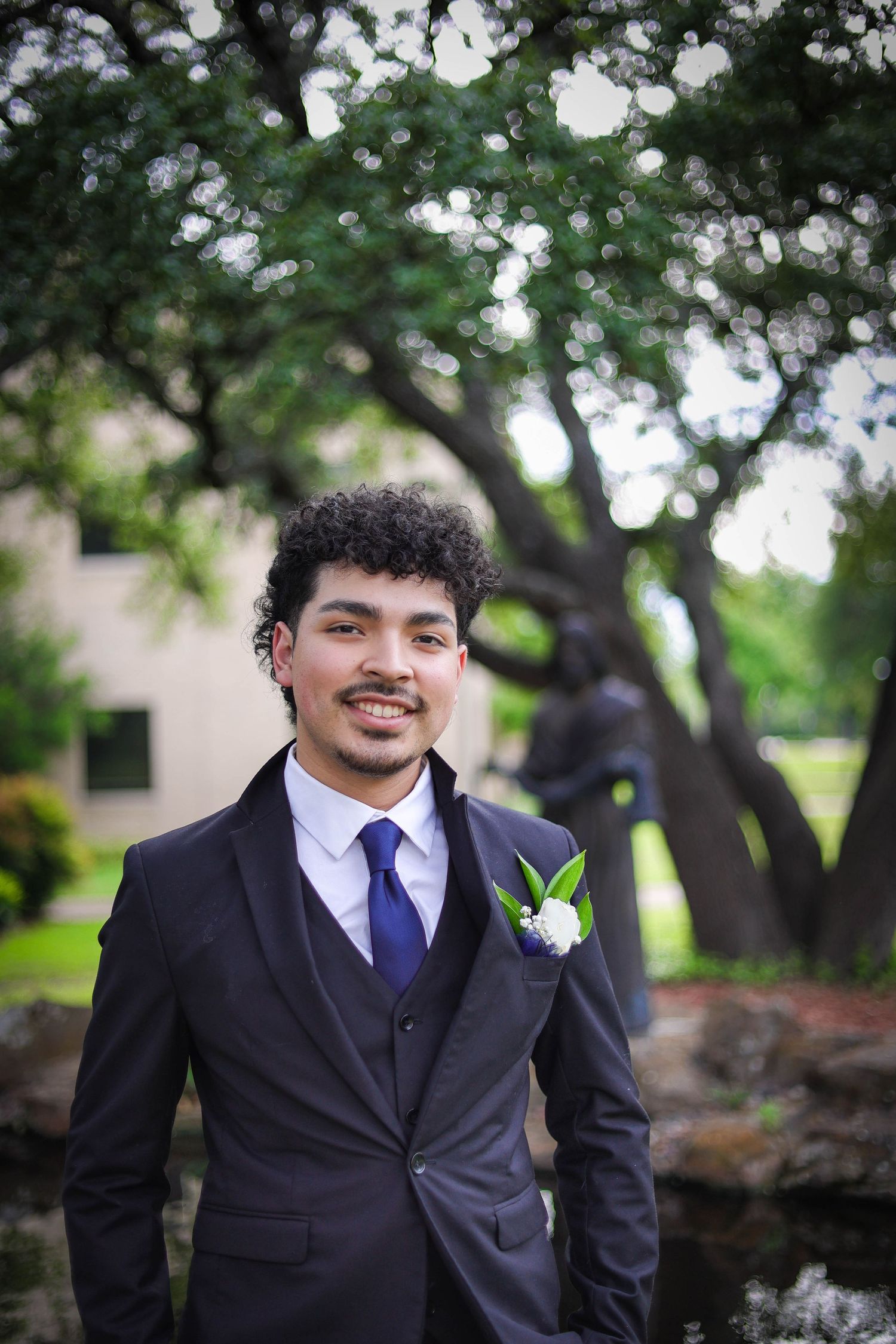 R.L. Paschal High School student poses in front of a historic college building during their prom photos.