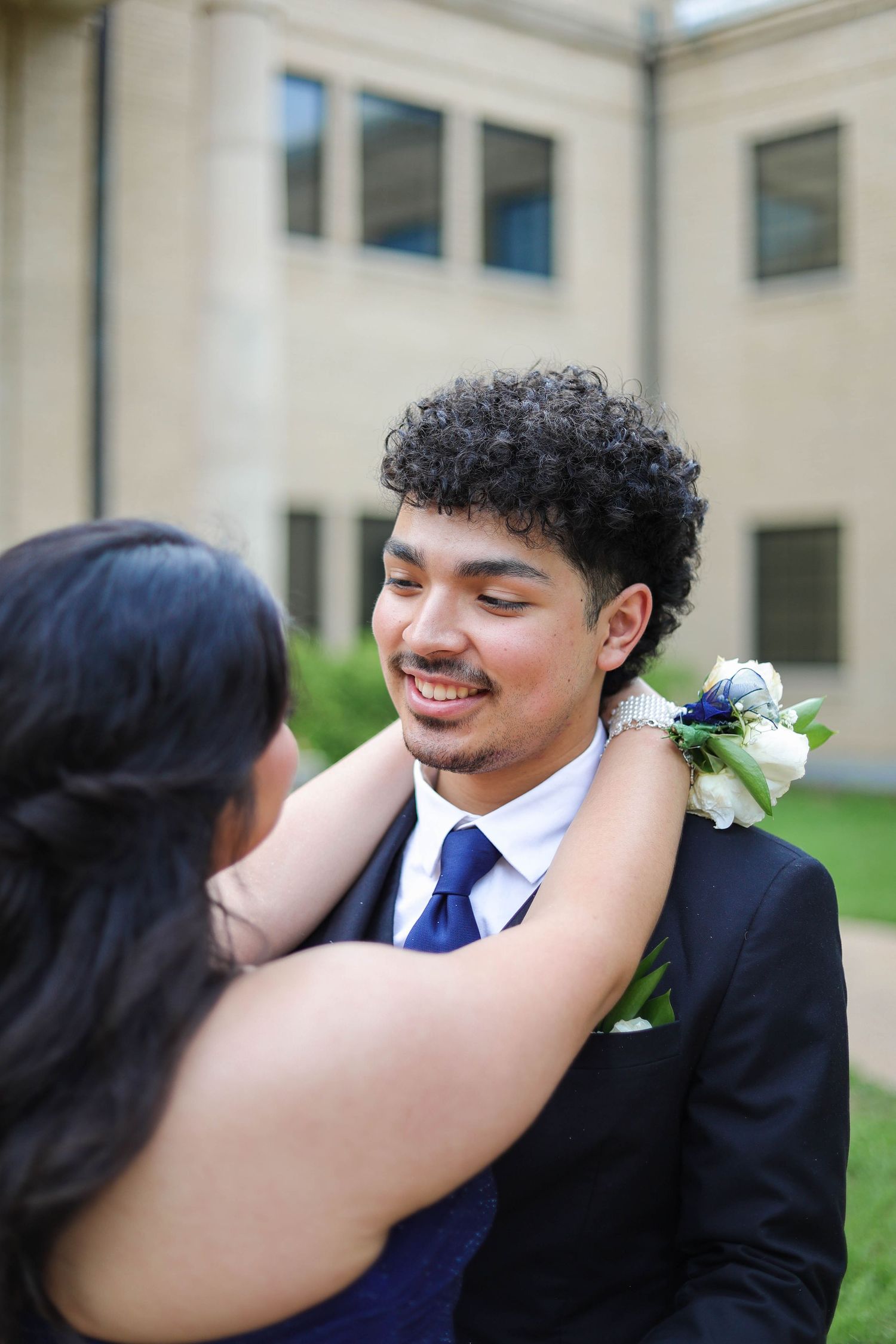R.L. Paschal High School students pose in front of a historic college building during their prom photos.