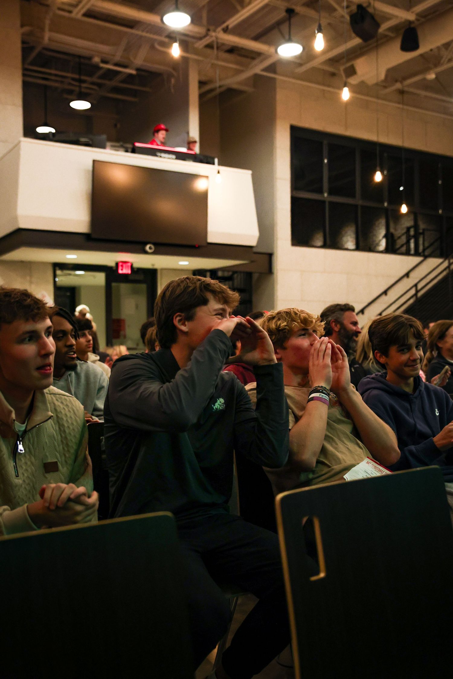 R.L. Paschal High School student supports a performer in YoungLife's annual Mr. Christmas Tree Pageant.