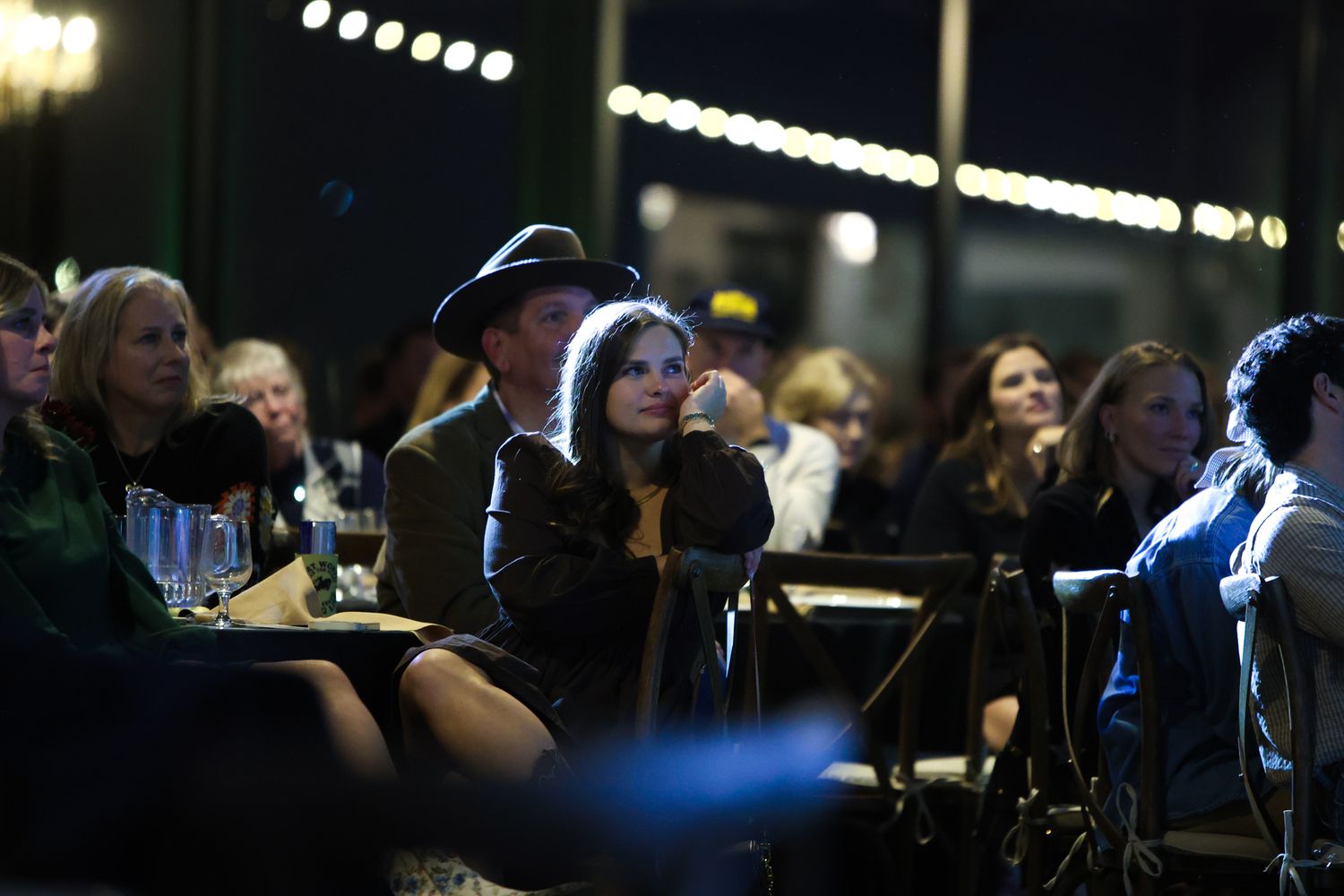 A guest at the Fort Worth YoungLife Banquet watches the inspiring video projected at the venue to show how YoungLife works in the community.