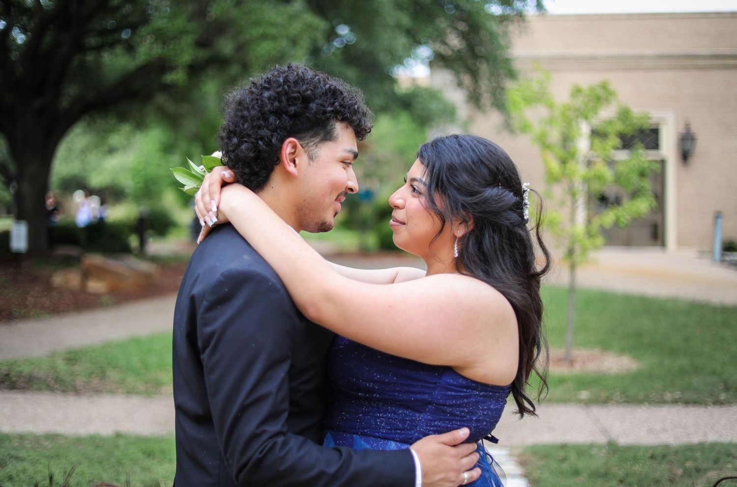R.L. Paschal High School students pose in front of a historic college building during their prom photos.