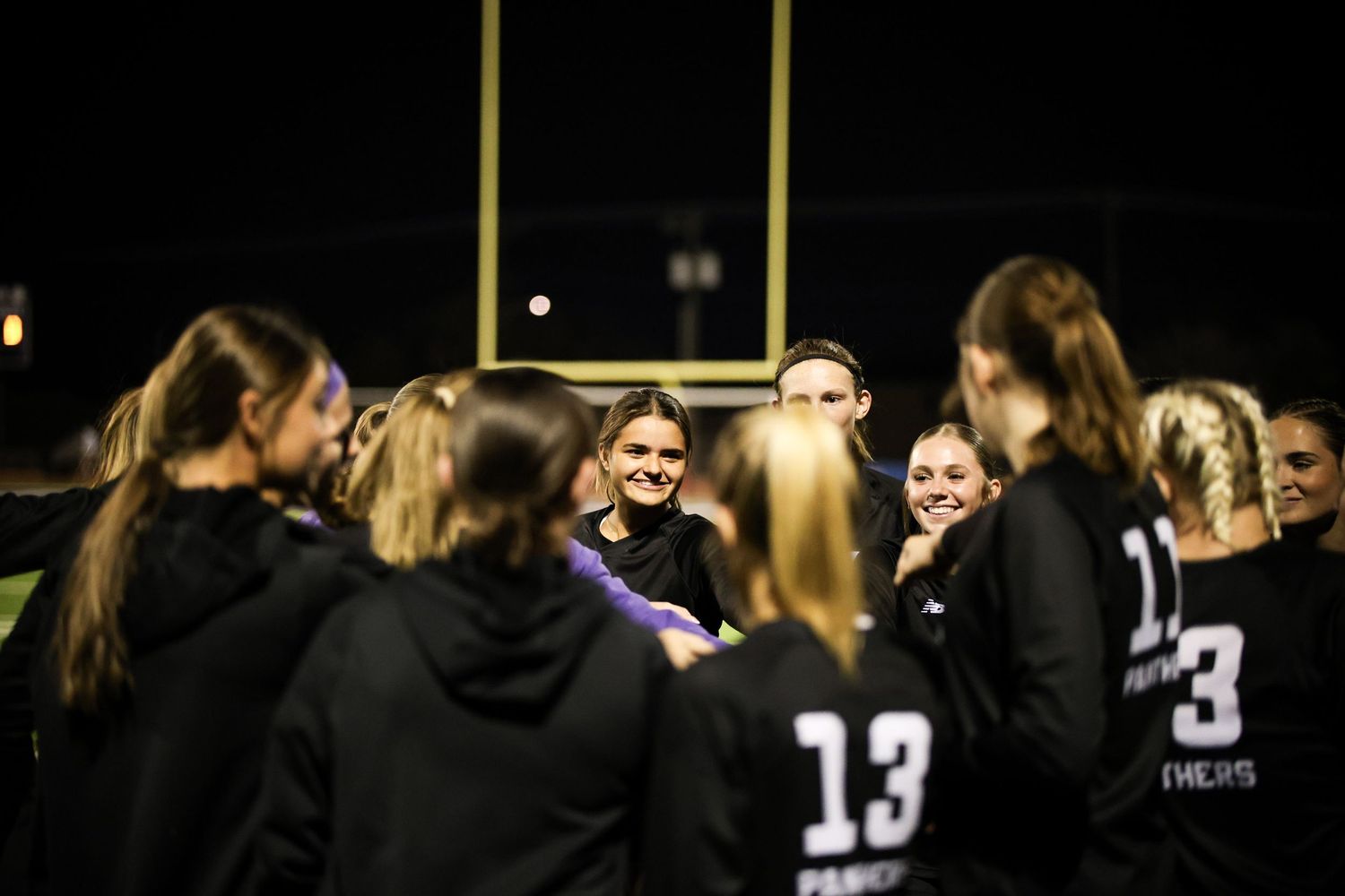 R.L. Paschal High School Varsity Girls Soccer player supports the team during their huddle time before their Senior Night game.
