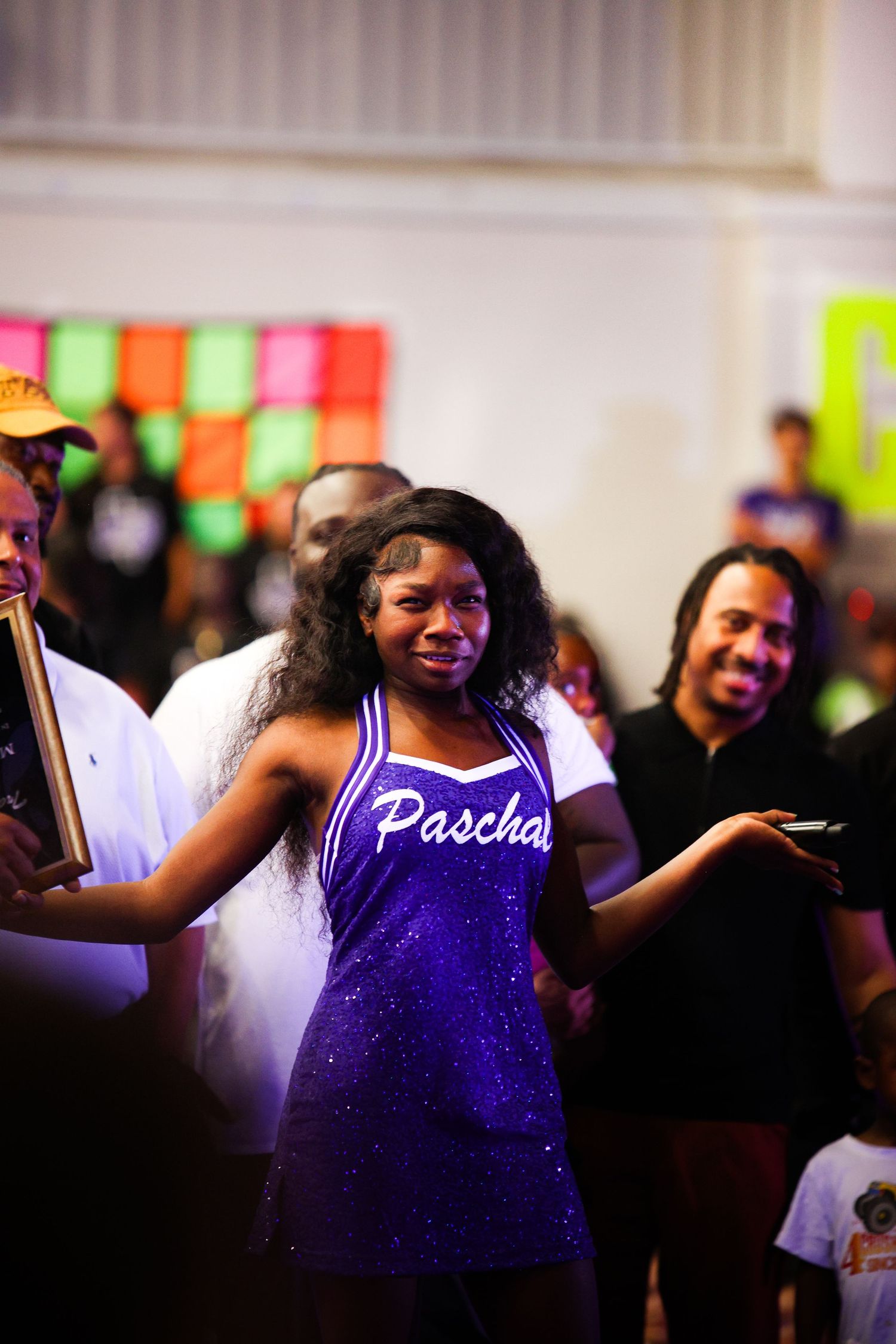 R.L. Paschal High School Step Team member talks to the crowd during the Homecoming Pep Rally to announce an award to a FWISD staff member.