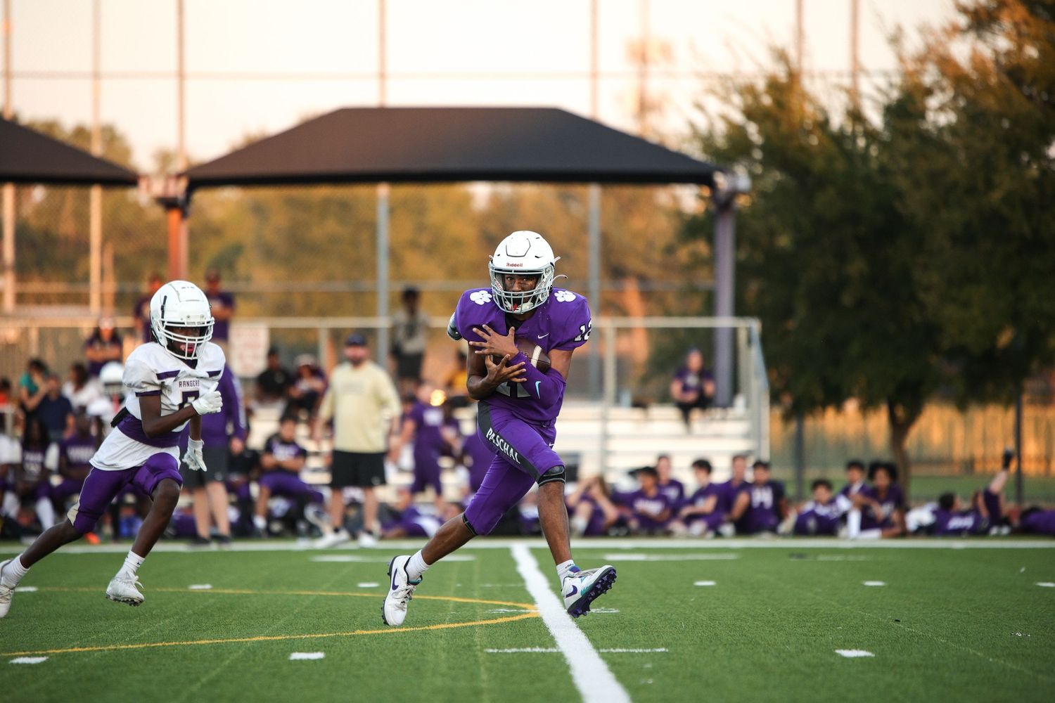 R.L. Paschal High School football player runs to score a touchdown after catching a long pass from the quarterback.