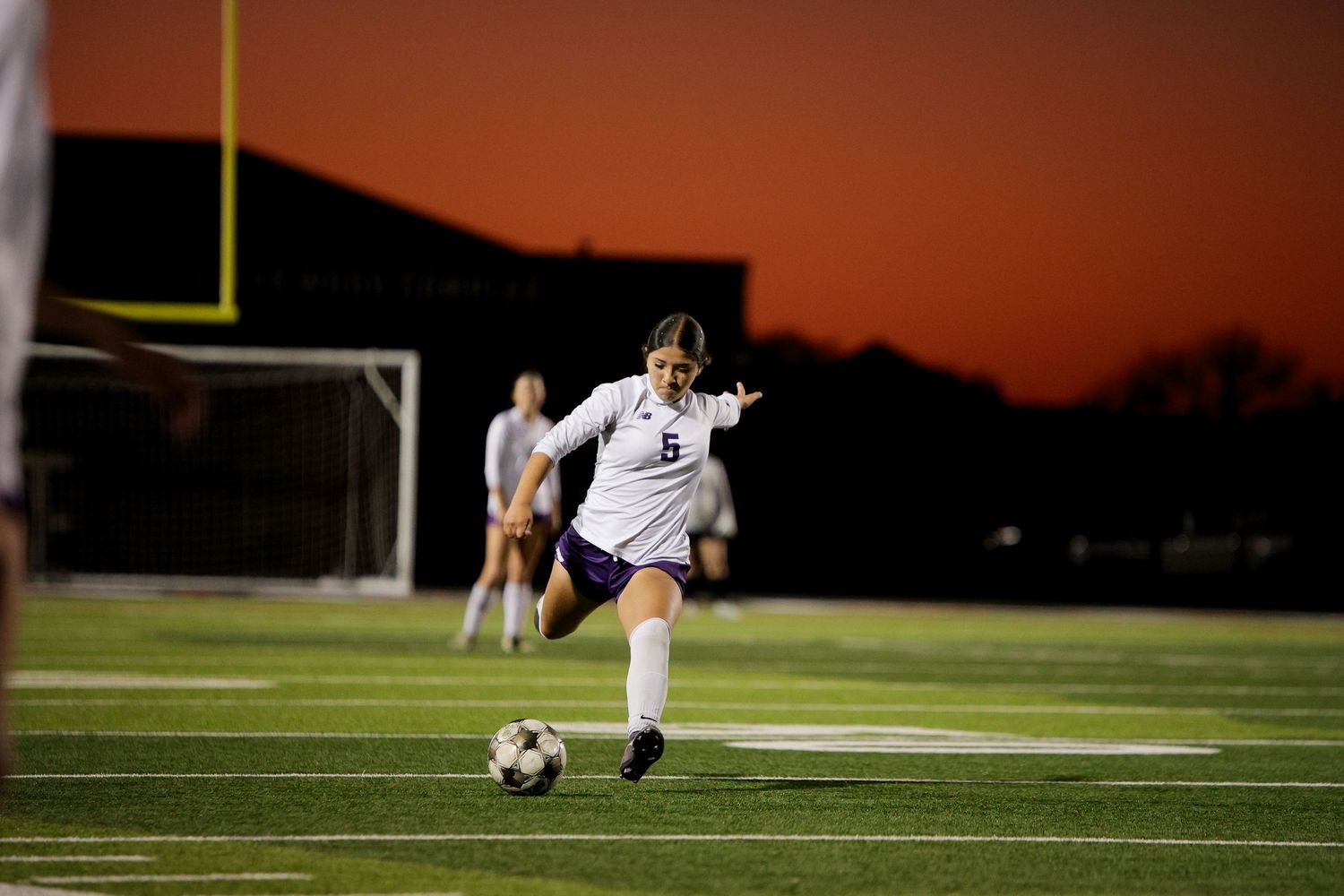 R.L. Paschal High School Varsity Girls Soccer Player kicks the ball up the field to hopefully score against in the Bi-District Championship.