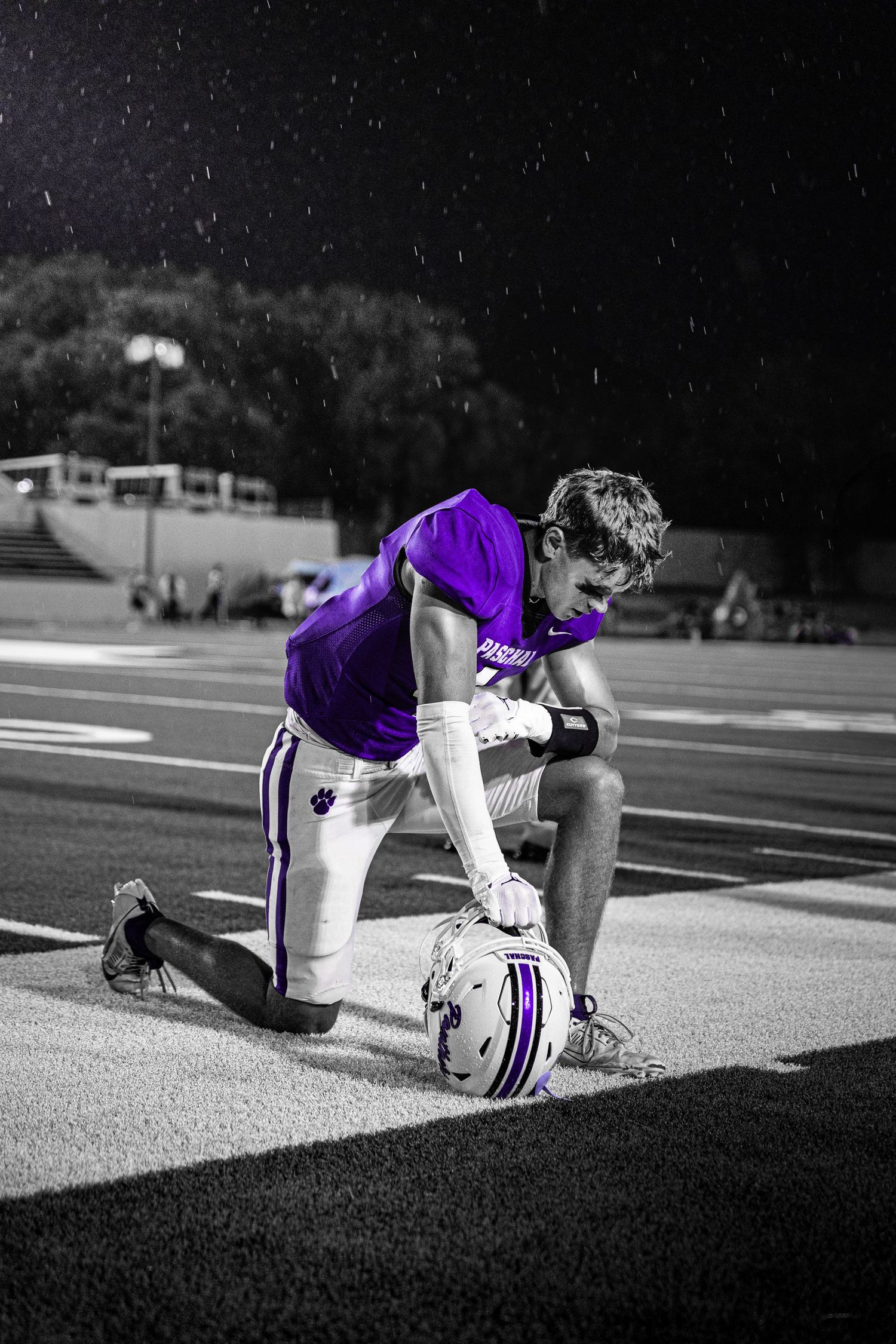 R.L. Paschal High School Varsity Football captain prays on Farrington Field before an opening game. The beginning of the purple reign.