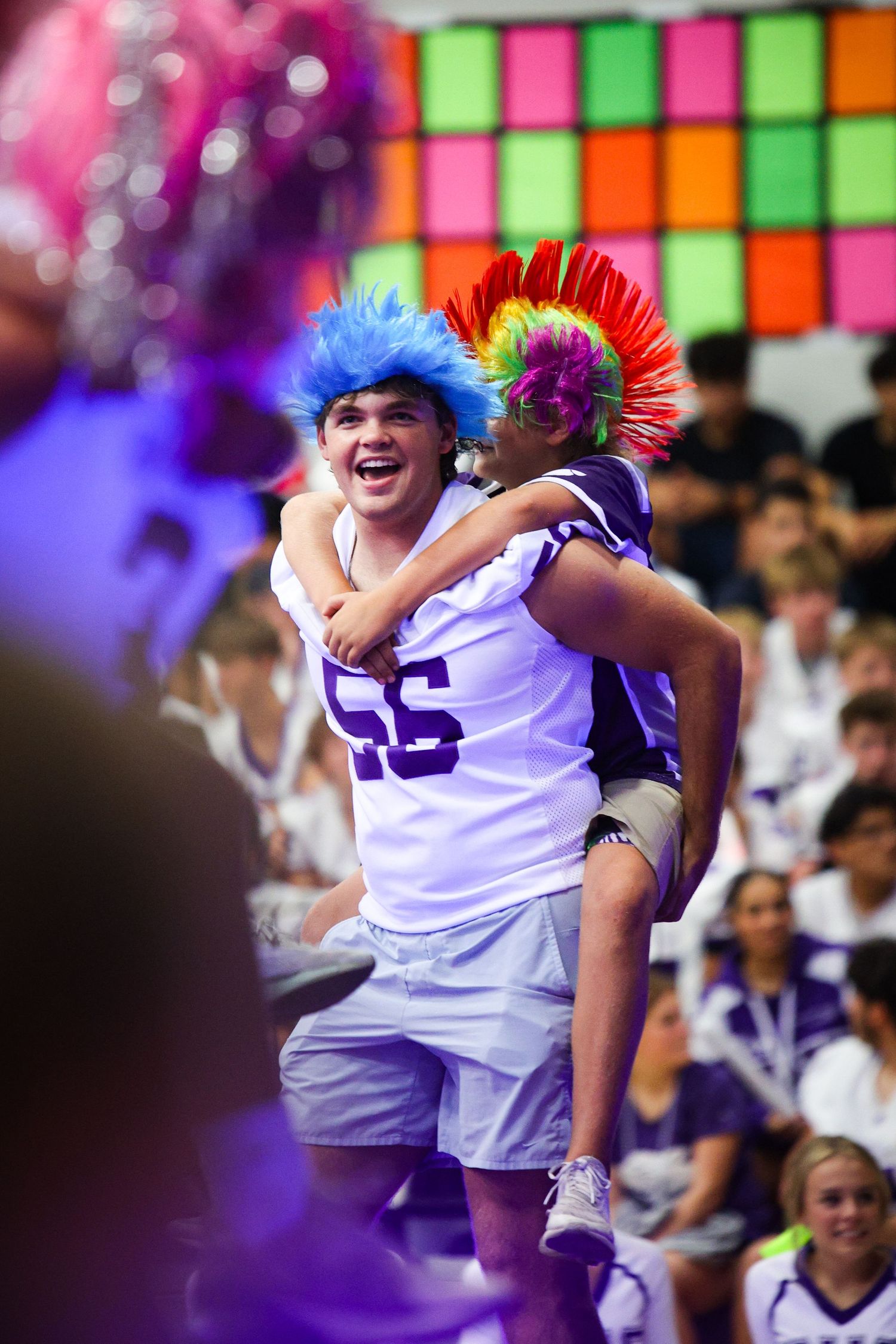 An R.L. Paschal High School Varsity Football player runs away from another at the Homecoming Pep Rally in a wig game.