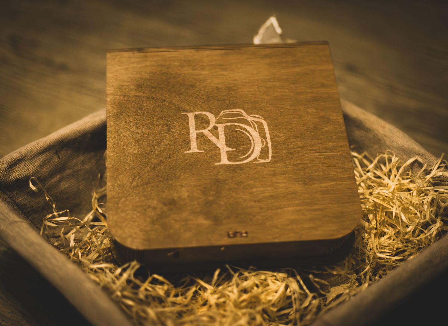 A wooden box with decorative wood shavings is photographed from different angles showing its rustic texture and design.