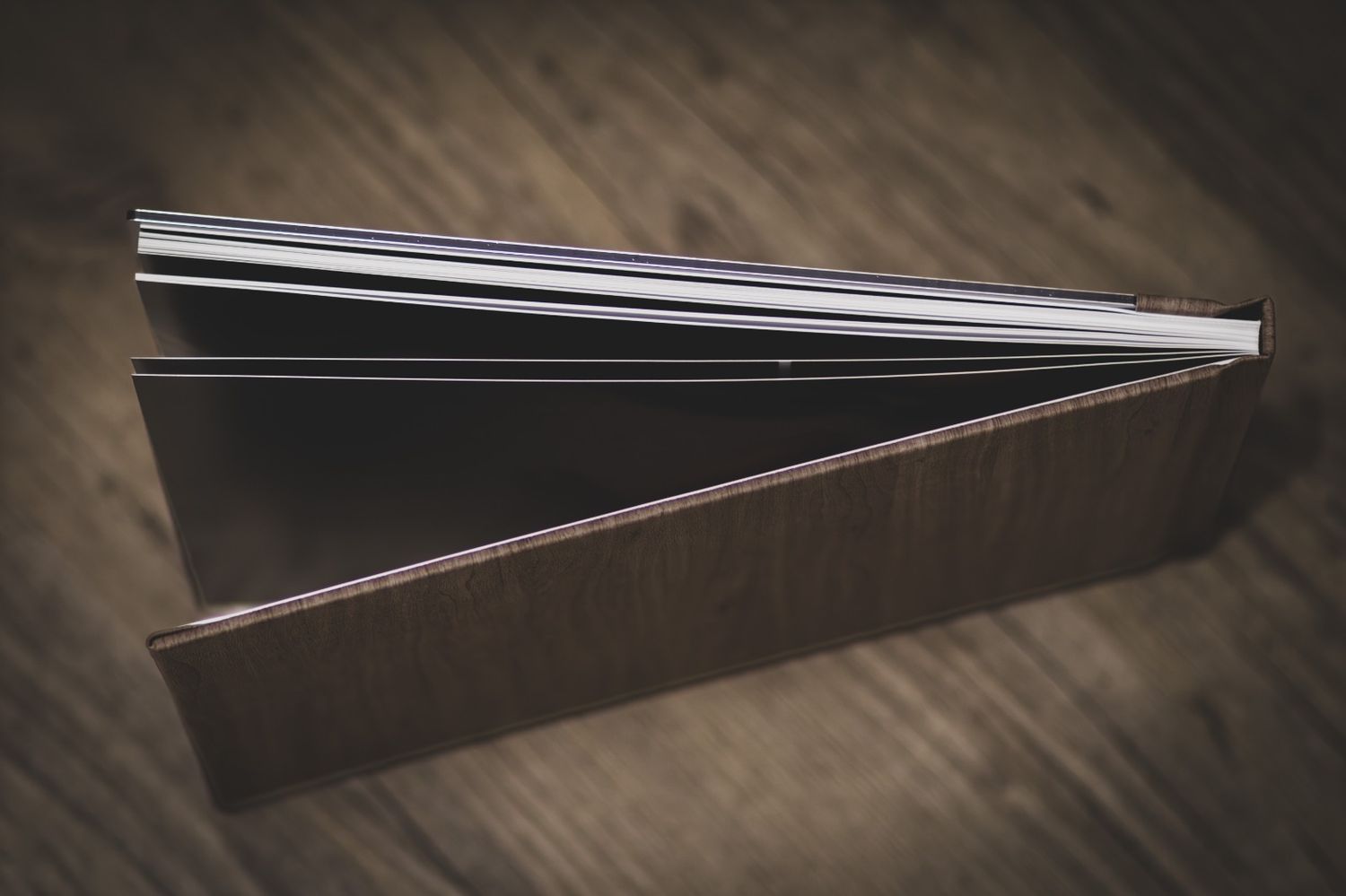 A sequence of six photos showing a black metal door hinge opening and closing against a dark wooden surface.