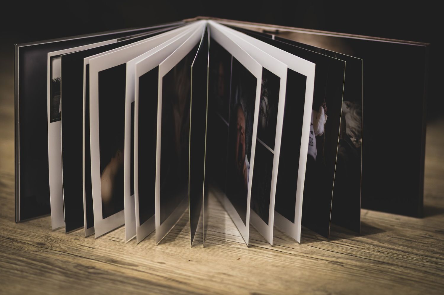 Artistic book installation with pages fanned out in a curved wave pattern creating a dynamic sculptural display.