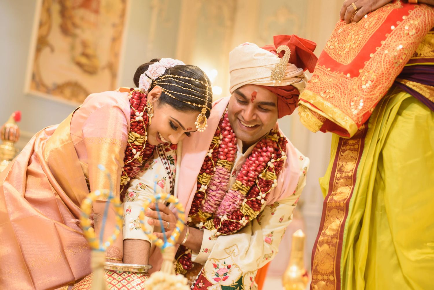 Hindu bride and groom perform sacred wedding rituals at ornate mandap ceremony.