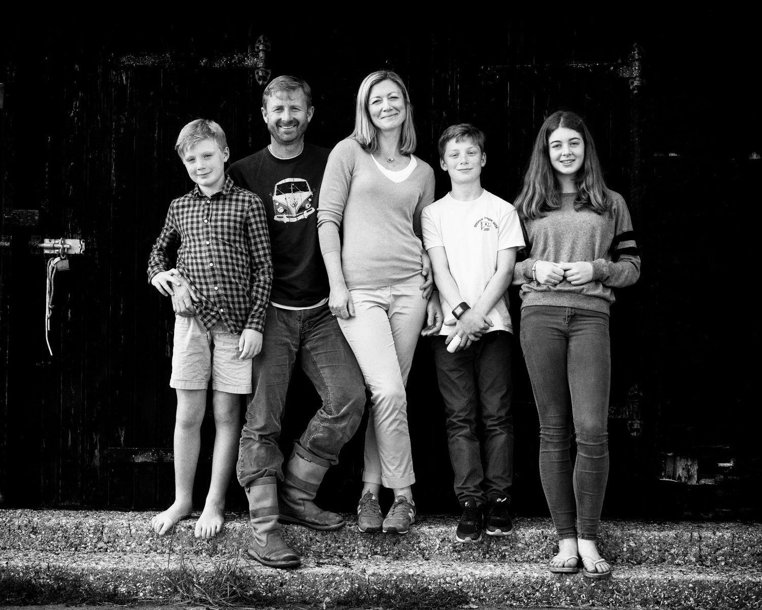 Family Group portrait series showing people standing together on steps in black and white.