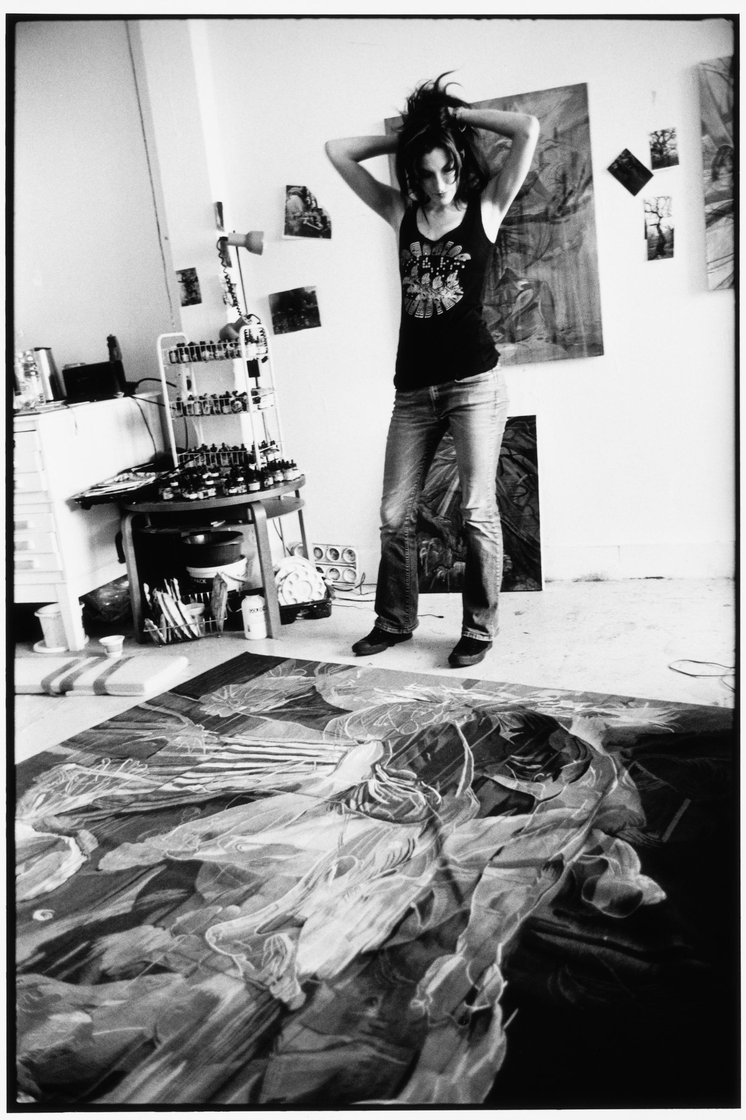 Artistic black and white series showing rumpled fabric on floor in studio space.