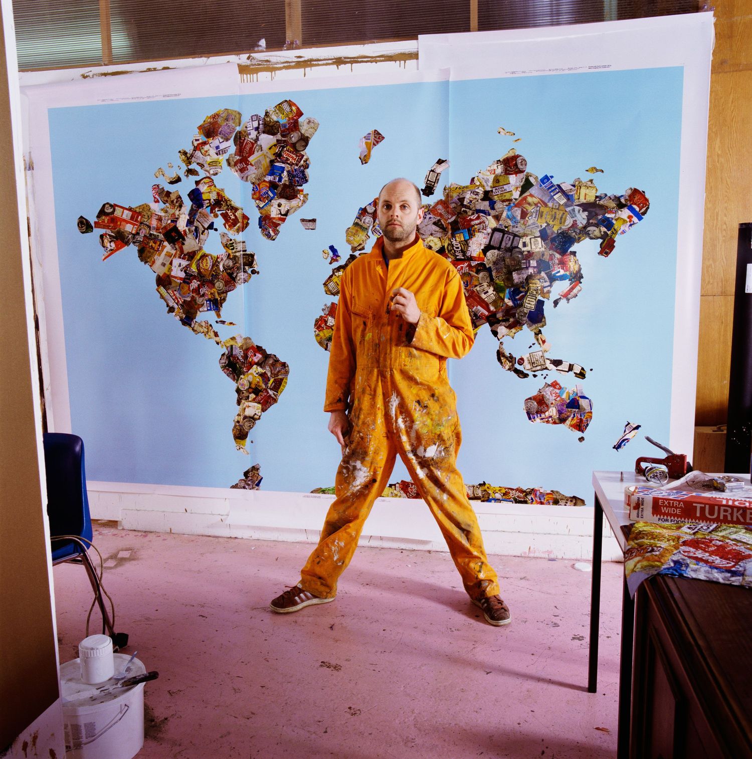 Person in yellow outfit performing dynamic movements against blue backdrop sequence.