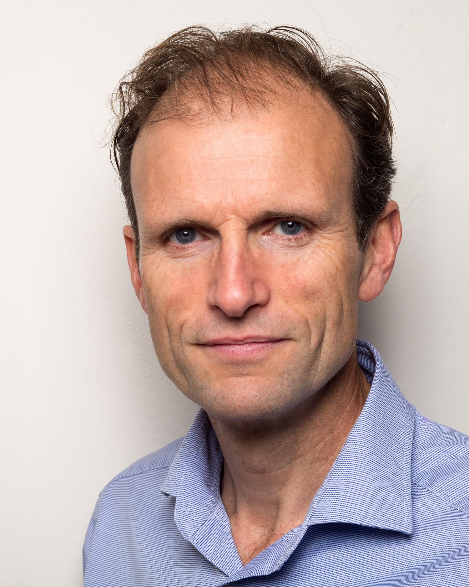 Series of headshot portraits of photographer Dan Stevens in a light blue collared shirt against a white background.