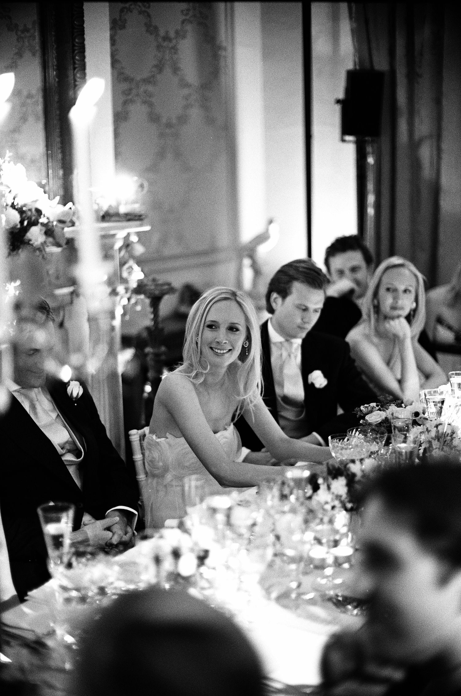 Black and white analogue candid shots of wedding reception dinner with candlelit tables. Leica rangefinder camera