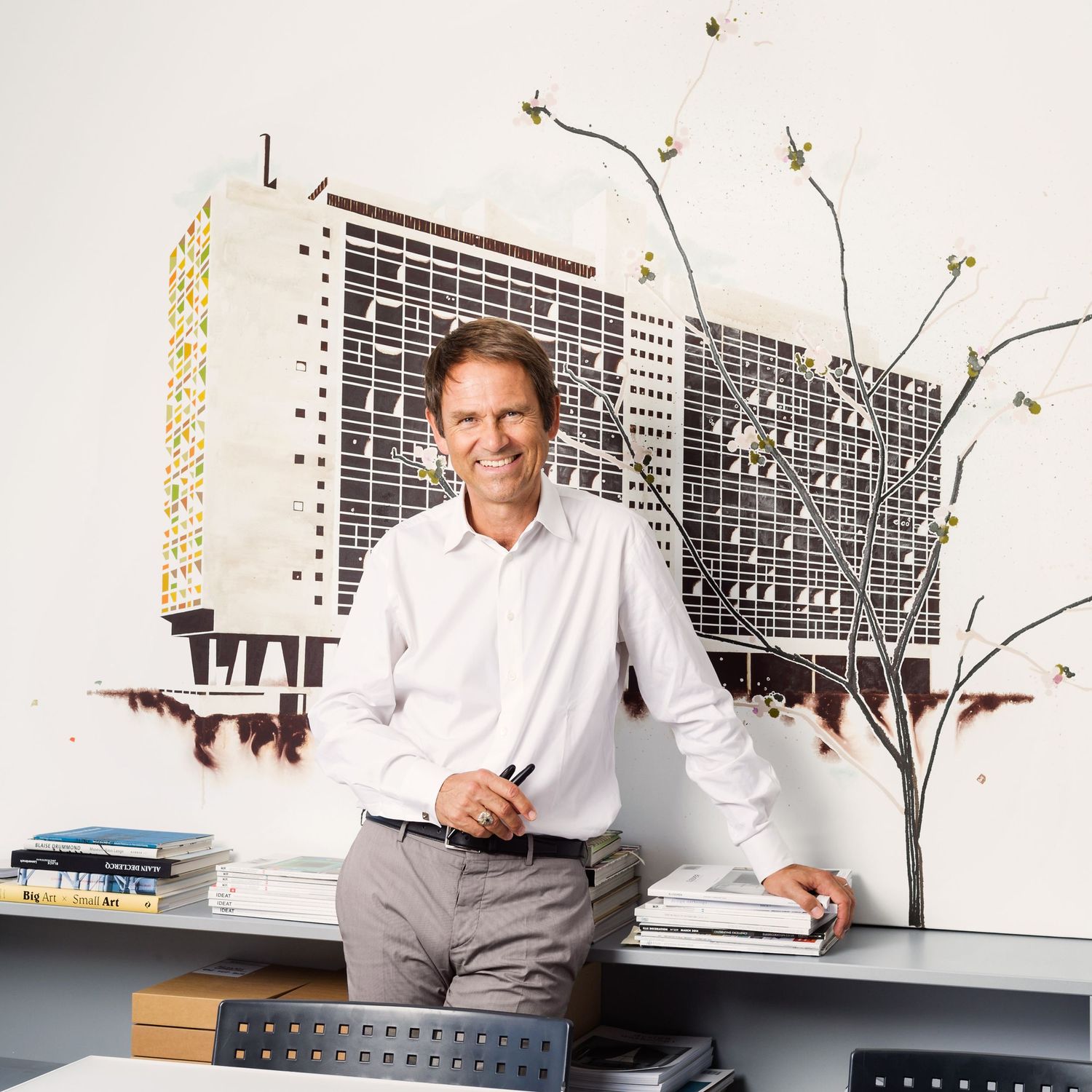 Modern office interior with architectural drawings and design documents on display.