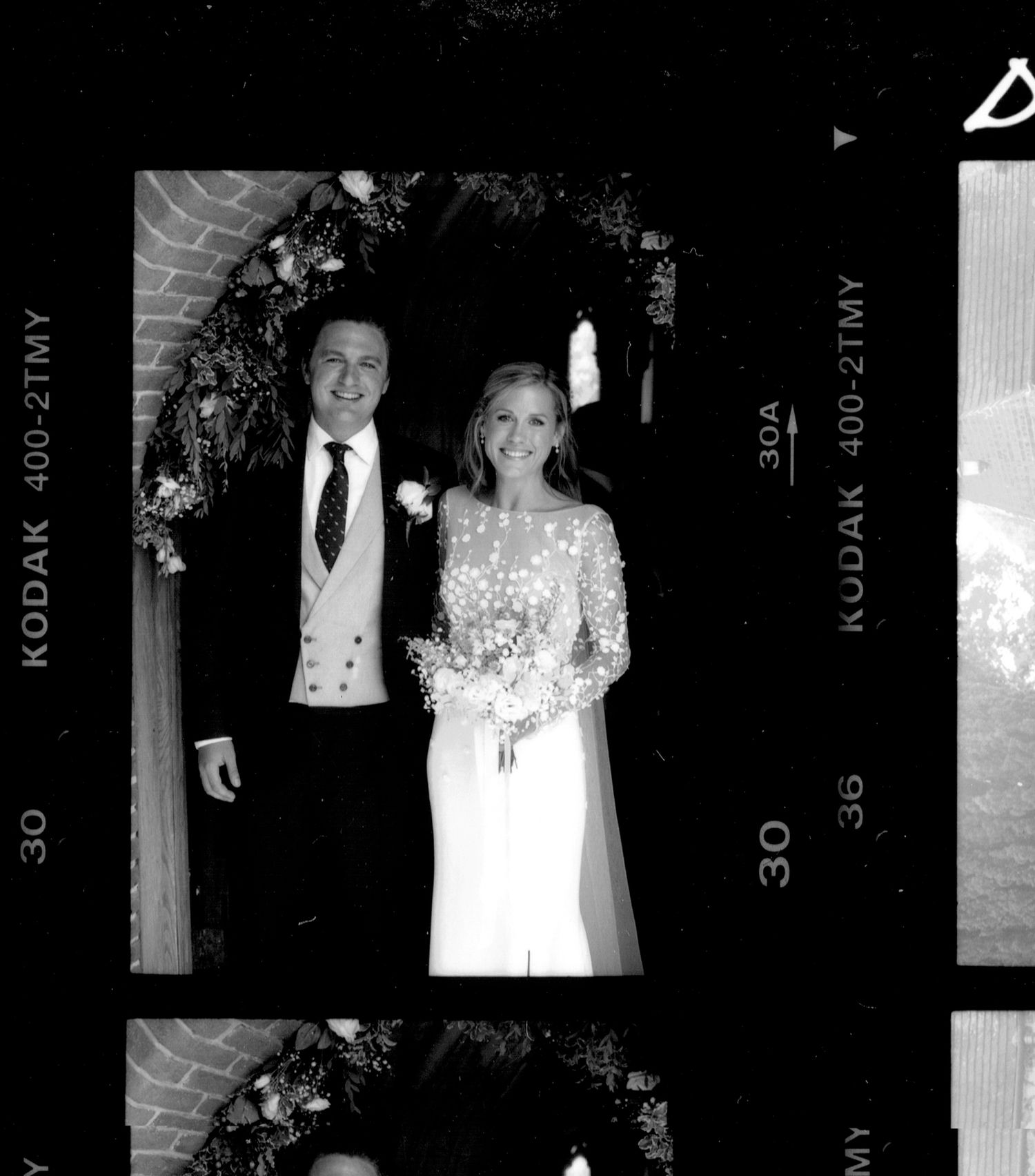 Black and white film negatives showing wedding dress details and portraits.