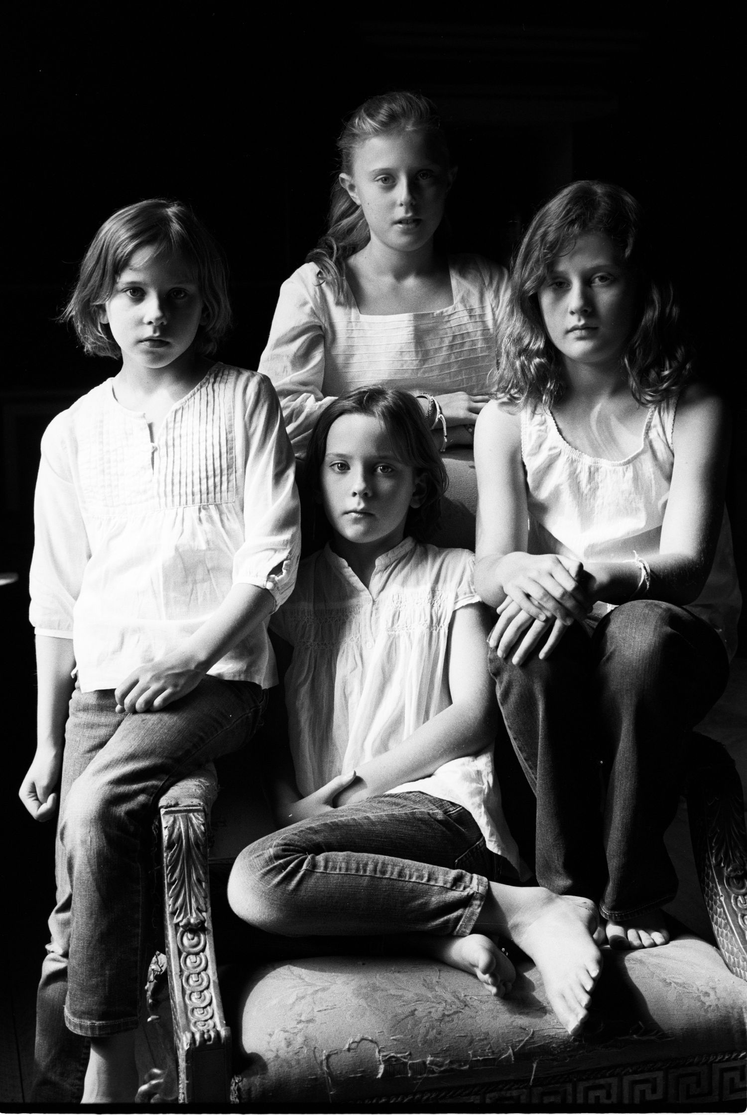 Dramatic black and white portrait of four young people in vintage style.