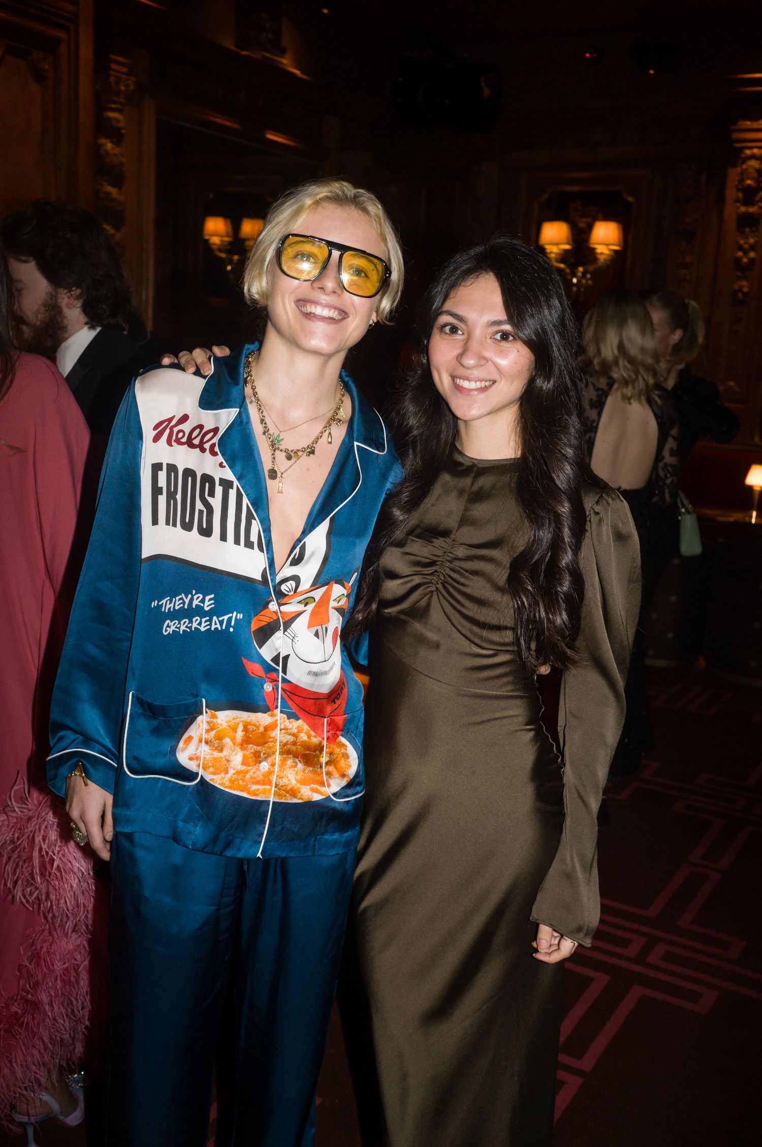 People mingling at a formal evening event wearing casual and dressy attire.
