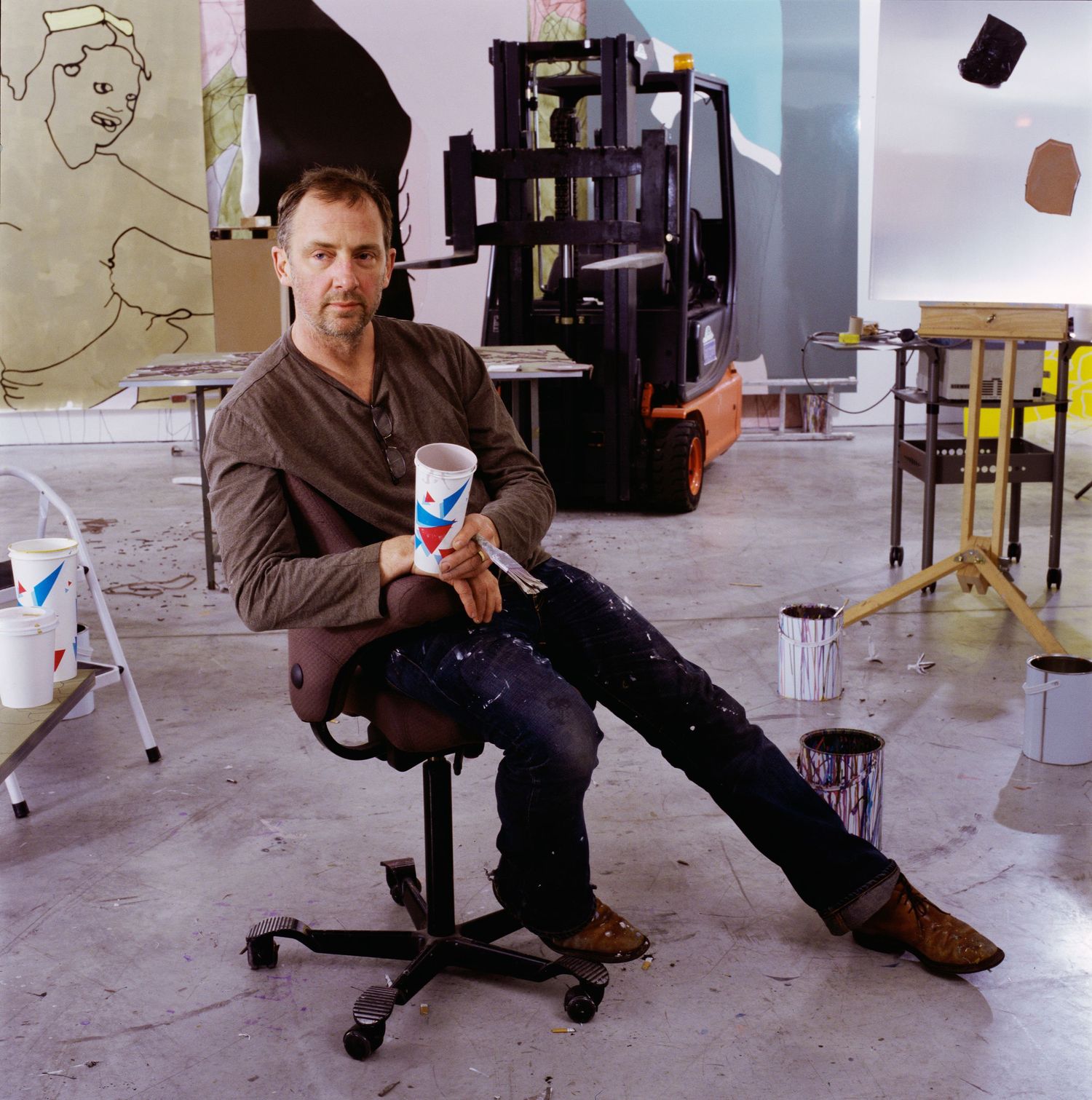 Artist demonstrating various seated poses in studio environment.