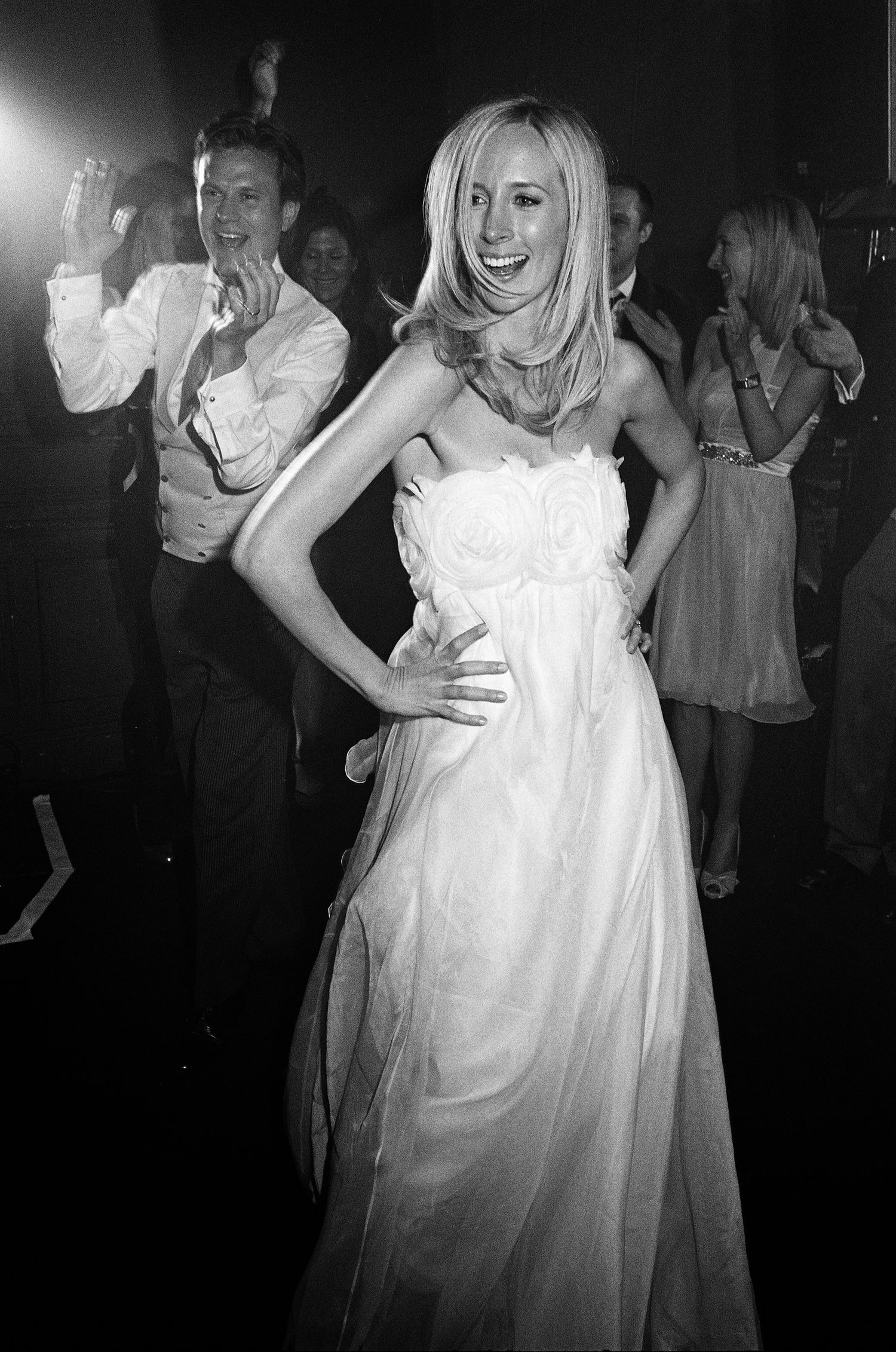 Black and white analogue photos of dancing and celebration at a wedding reception.