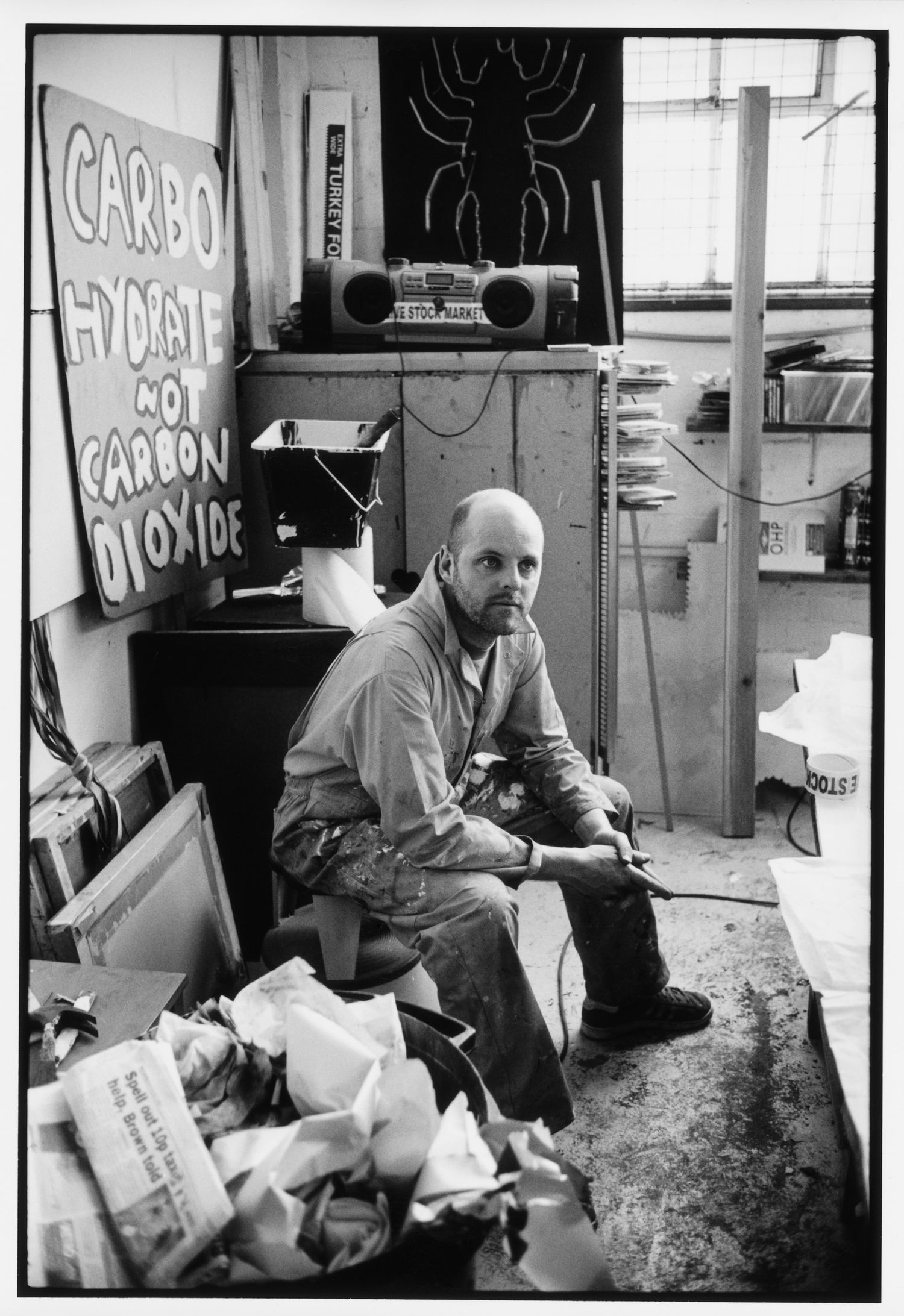 Black and white photos showing a casual indoor scene with scattered objects.